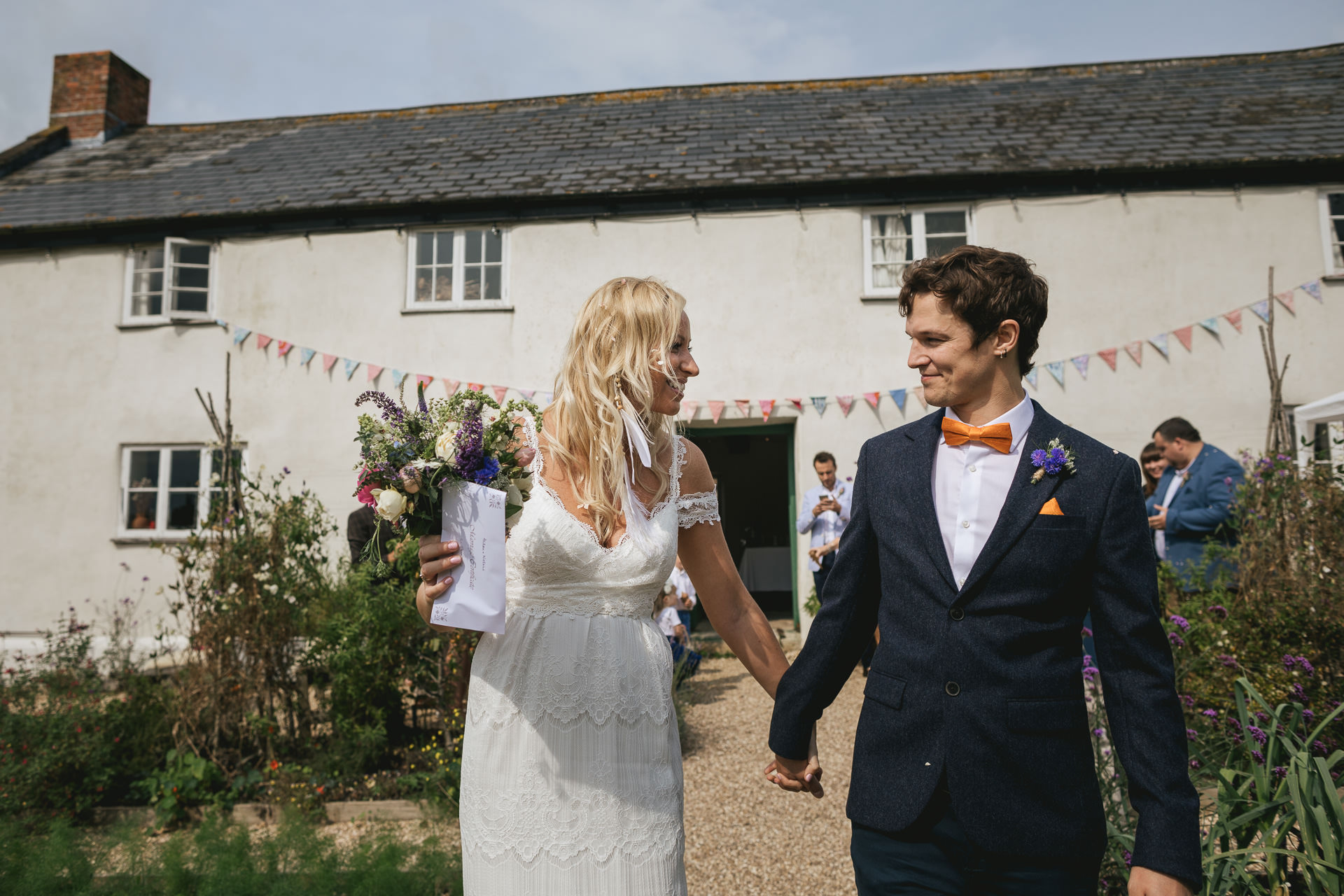 Bride and groom smiling at each other outside River Cottage farmhouse