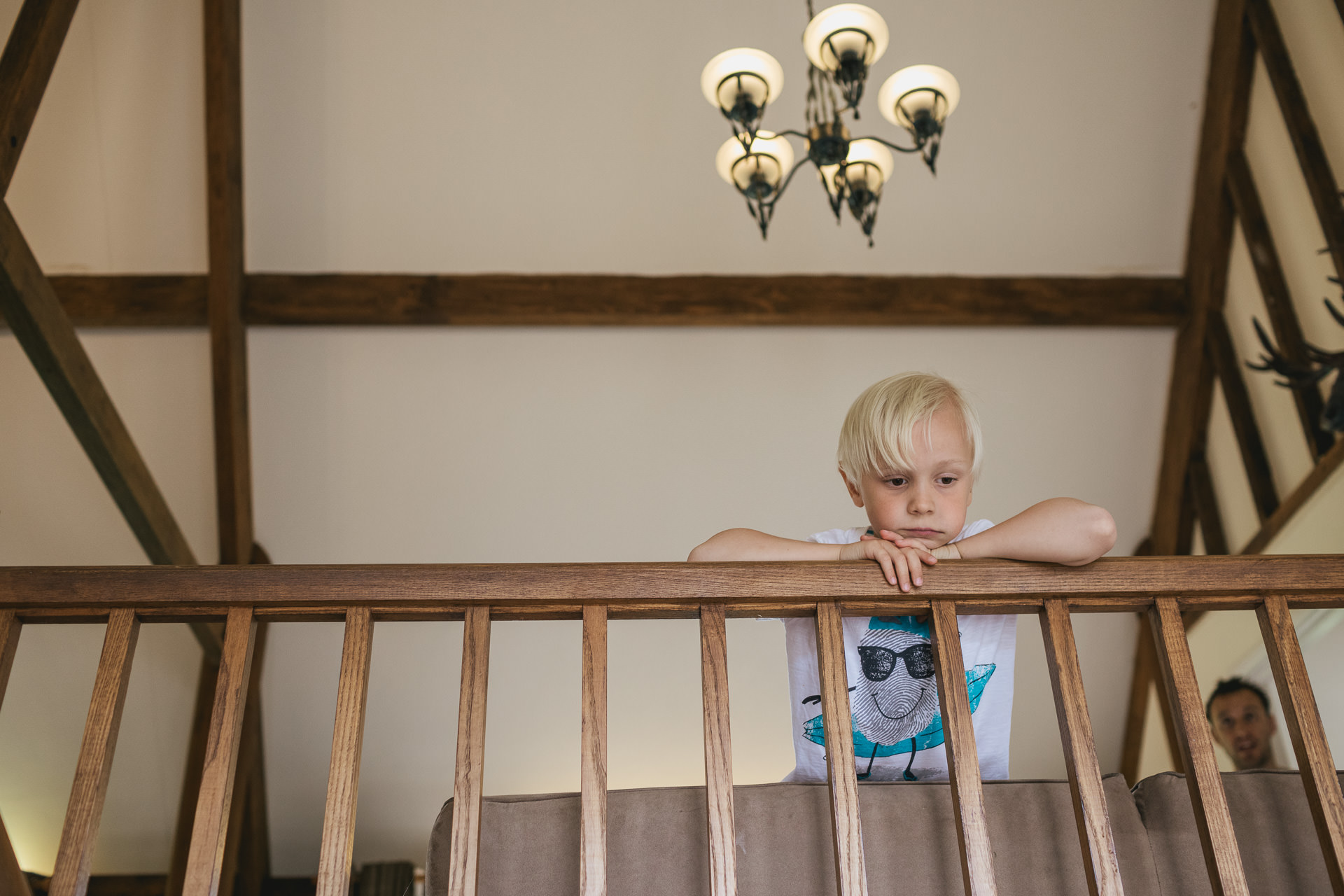 Young pageboy looking over a bannister