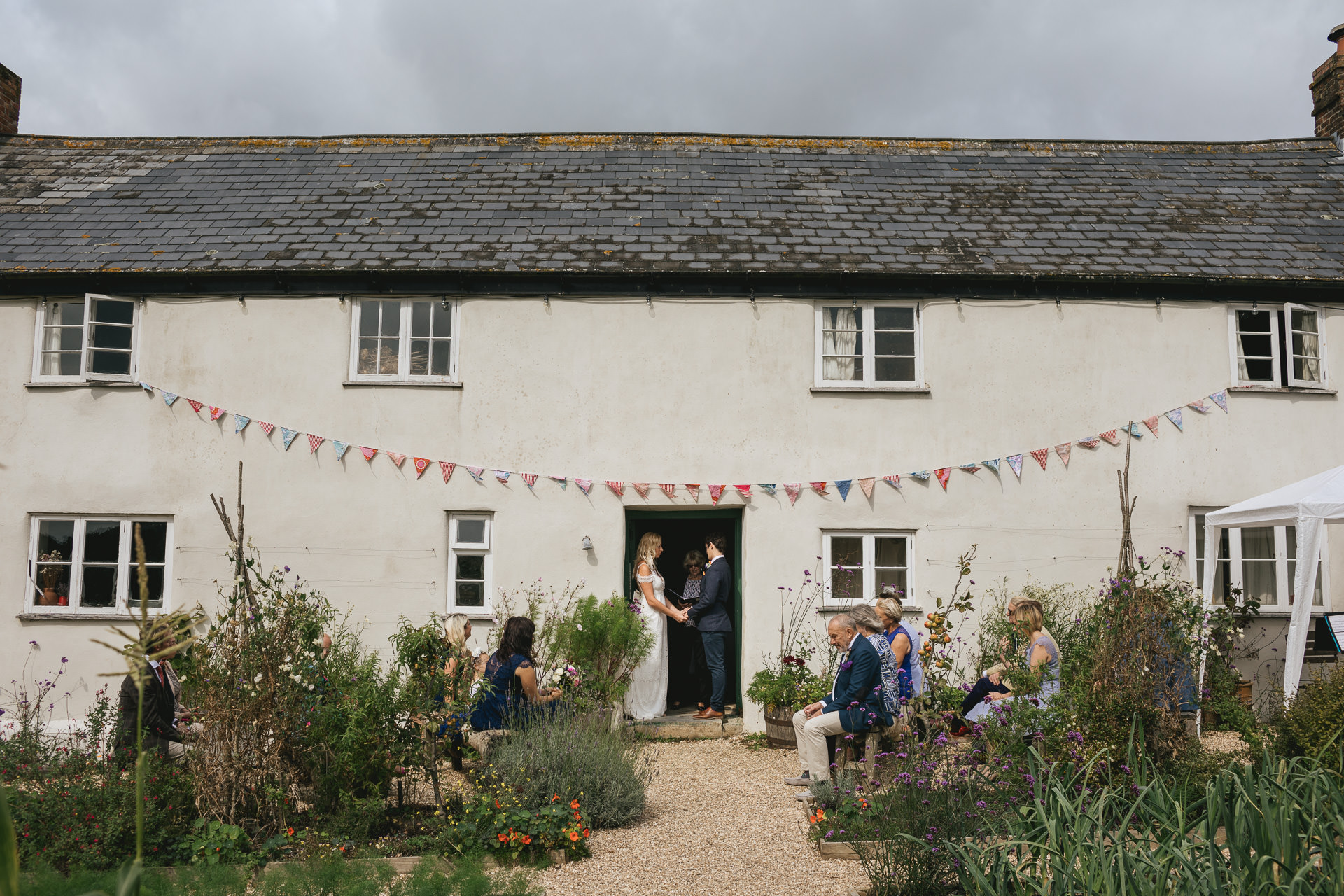 Bride and groom saying wedding vows at River Cottage farmhouse
