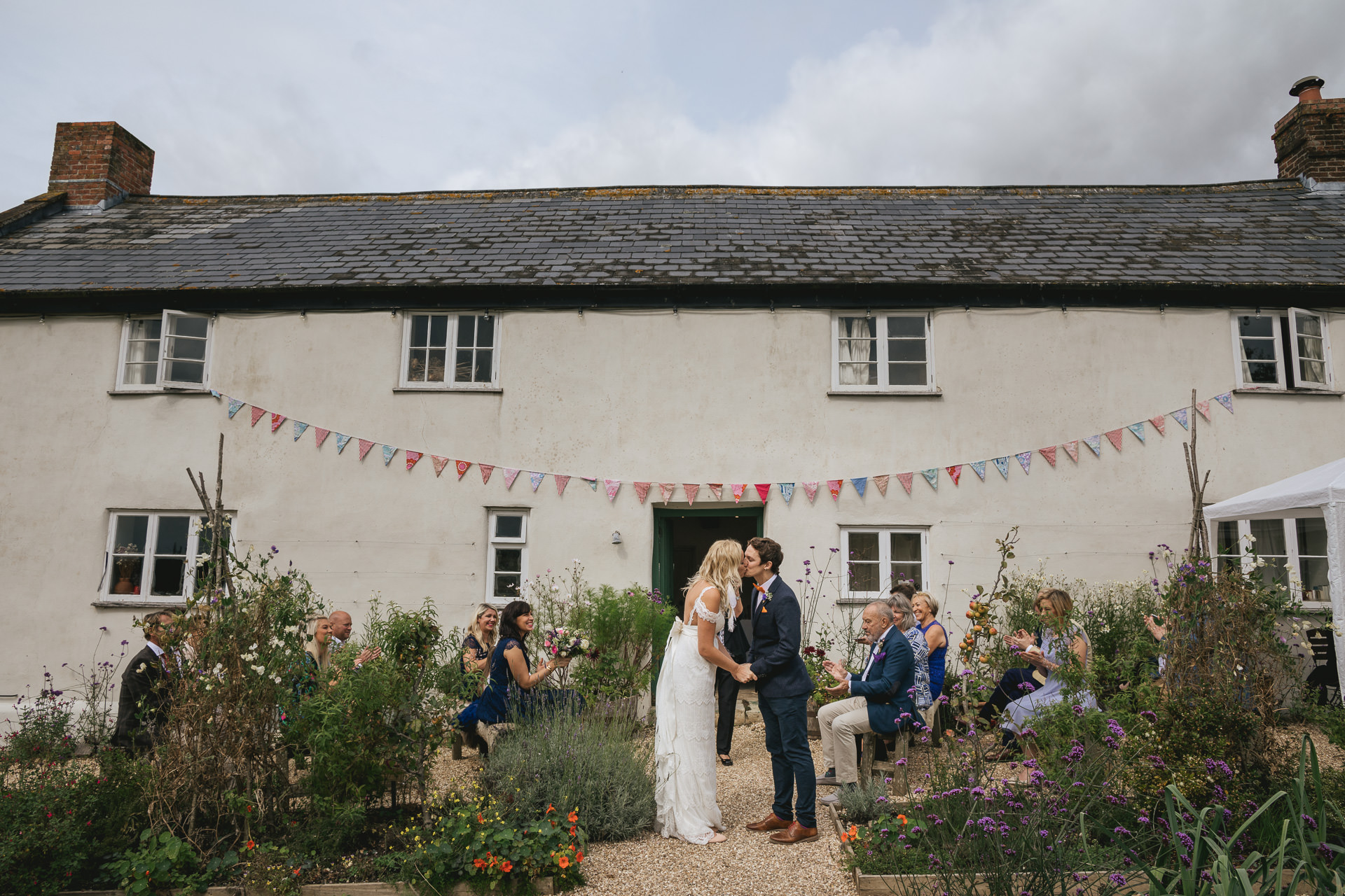 Bride and groom first kiss at River Cottage