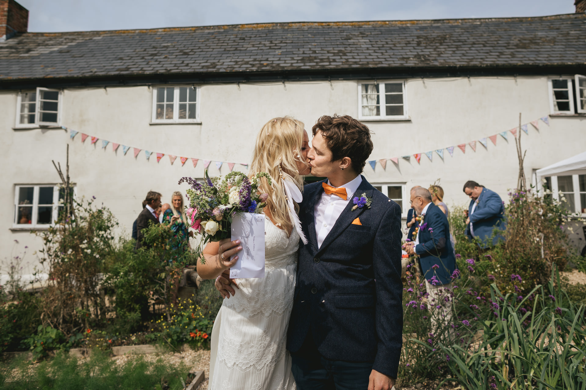 Bride and groom kissing outside River Cottage farmhouse