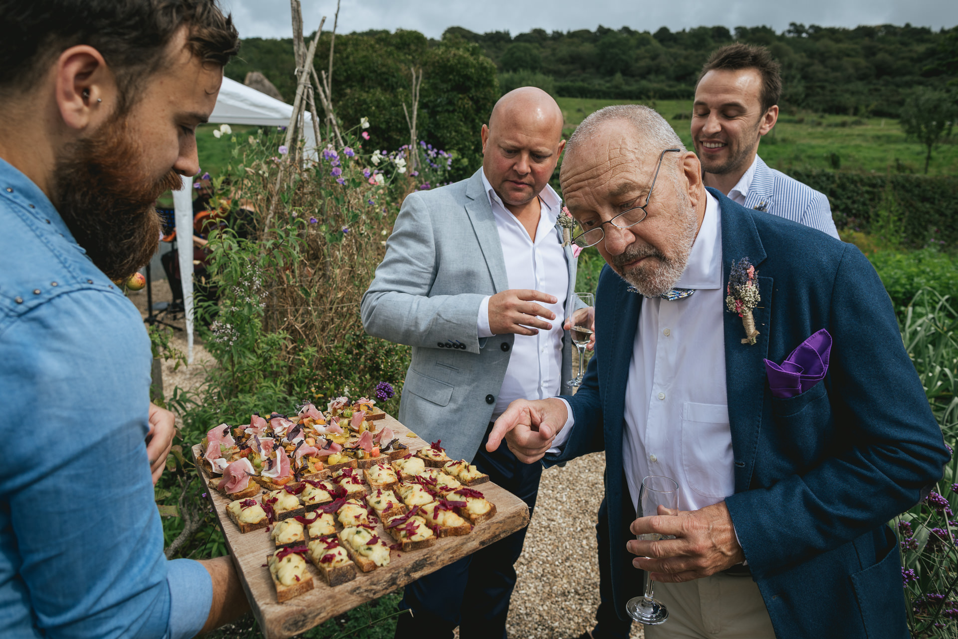 Father of the bride looking at wedding canapés