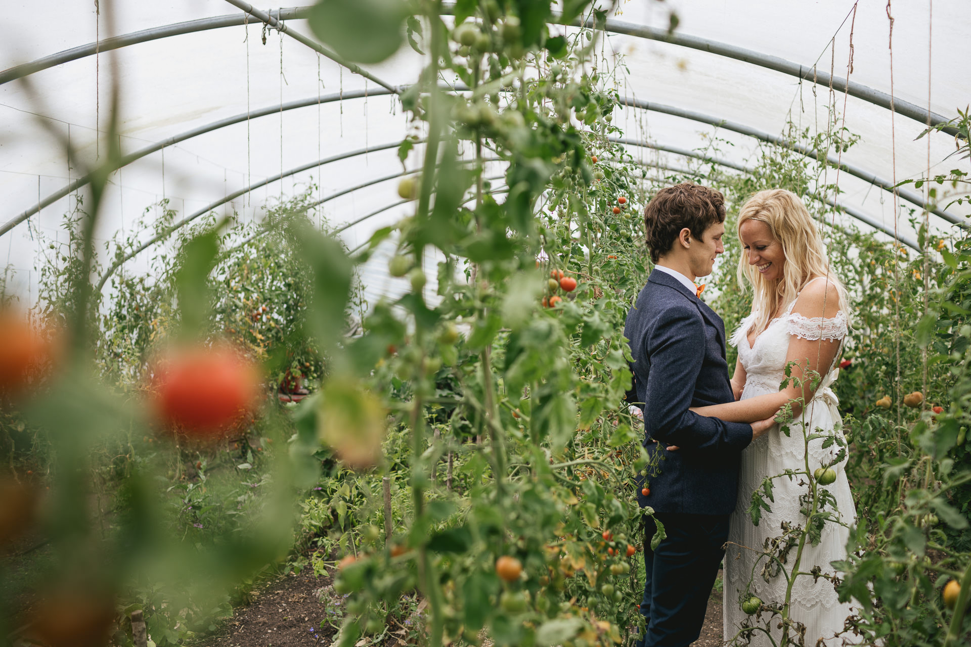 Bride and groom with tomato plants at River Cottage