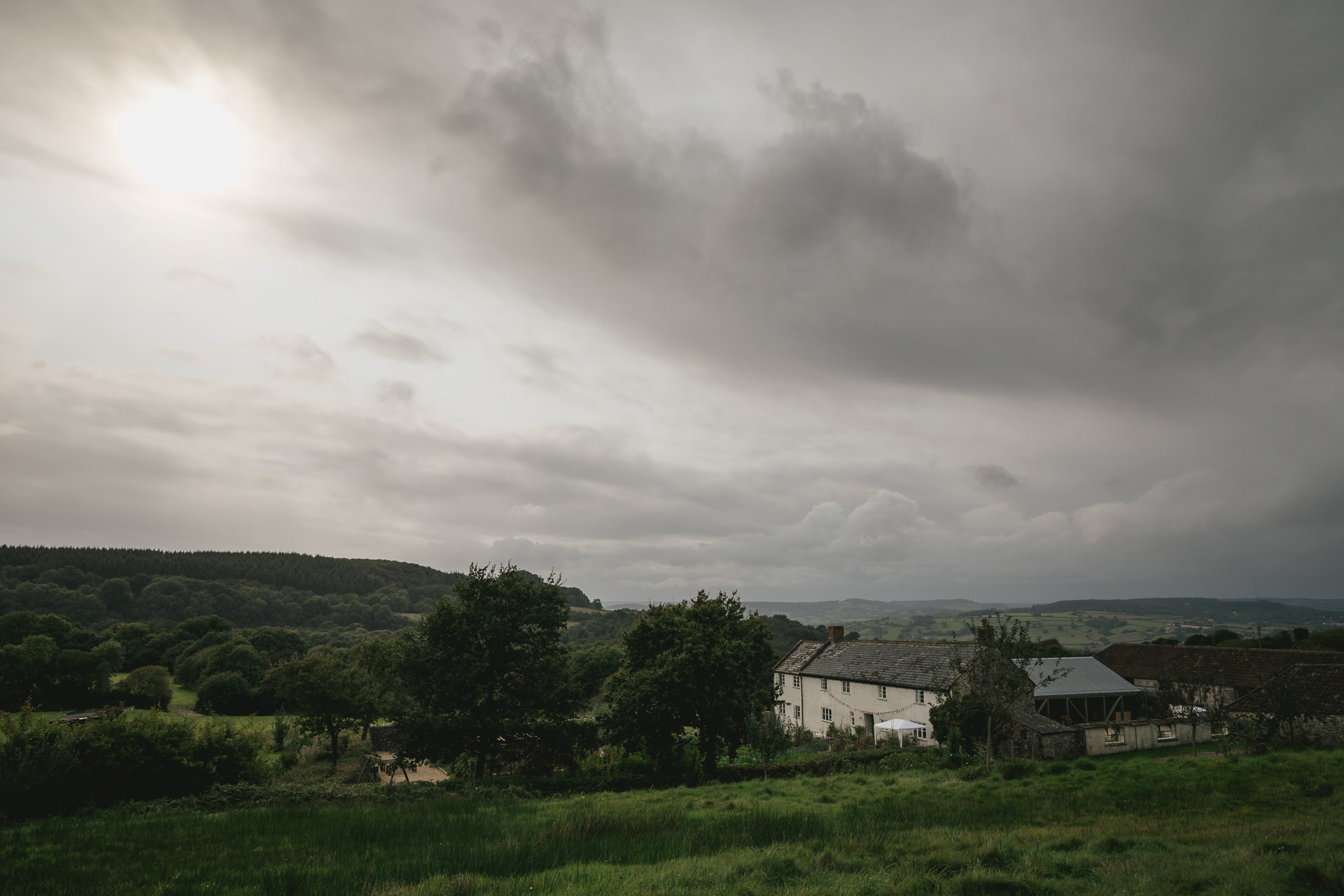 Atmospheric shot of River Cottage with clouds overhead