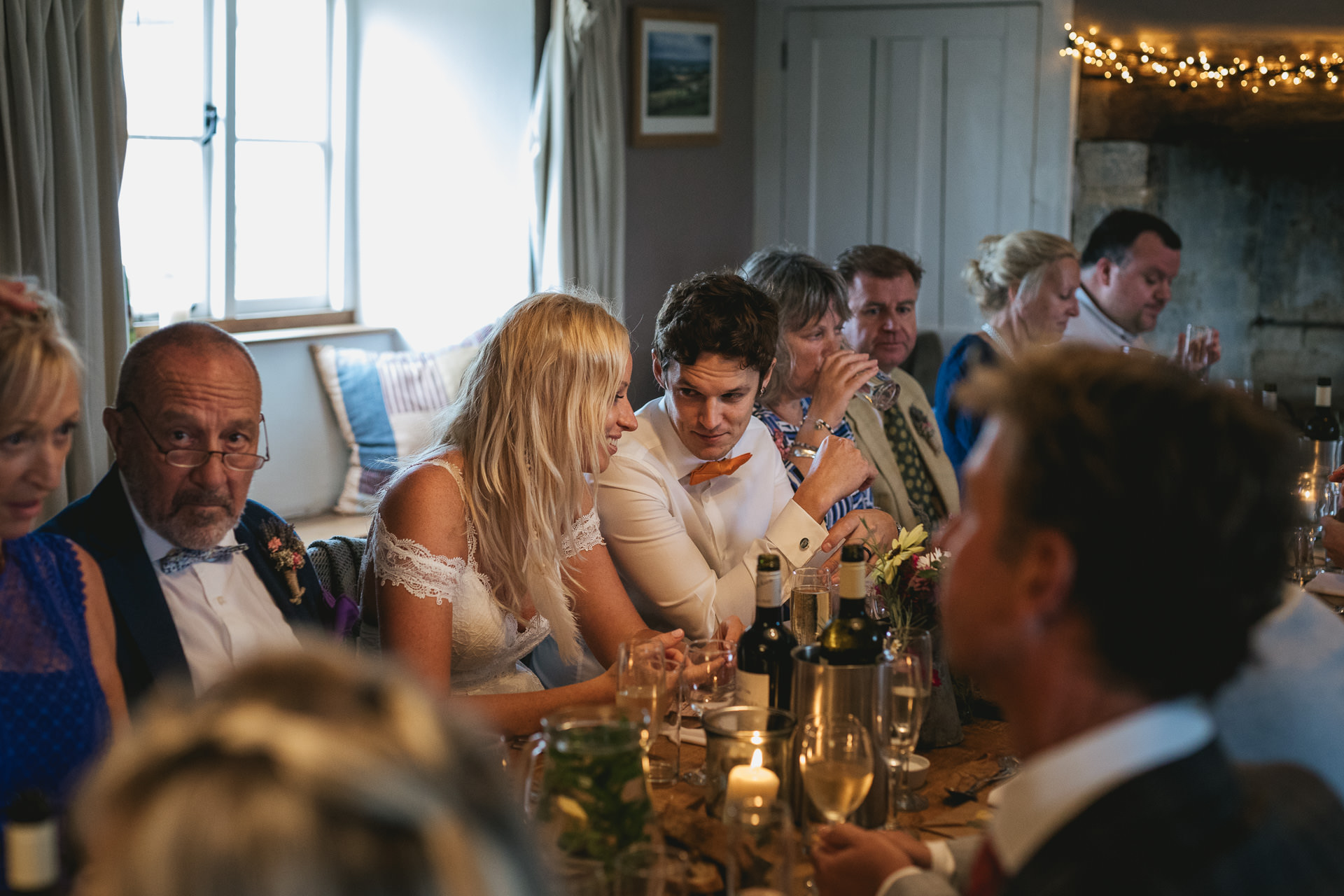 Wedding guests chatting around the table at river cottage