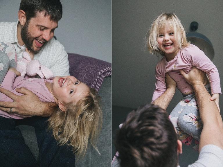 Relaxed family photos of a young girl laughing in her father's arms