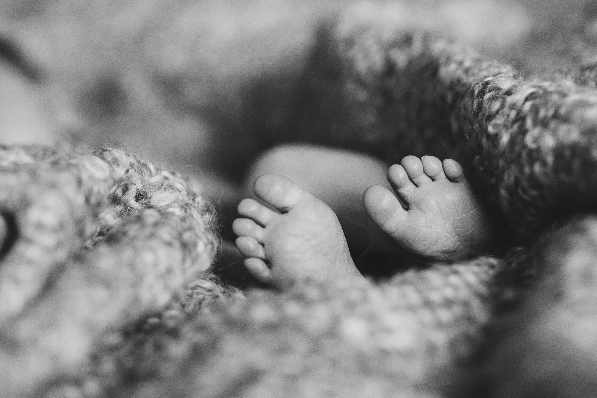 Close up of newborn baby's feet during a photography session at home in Devon