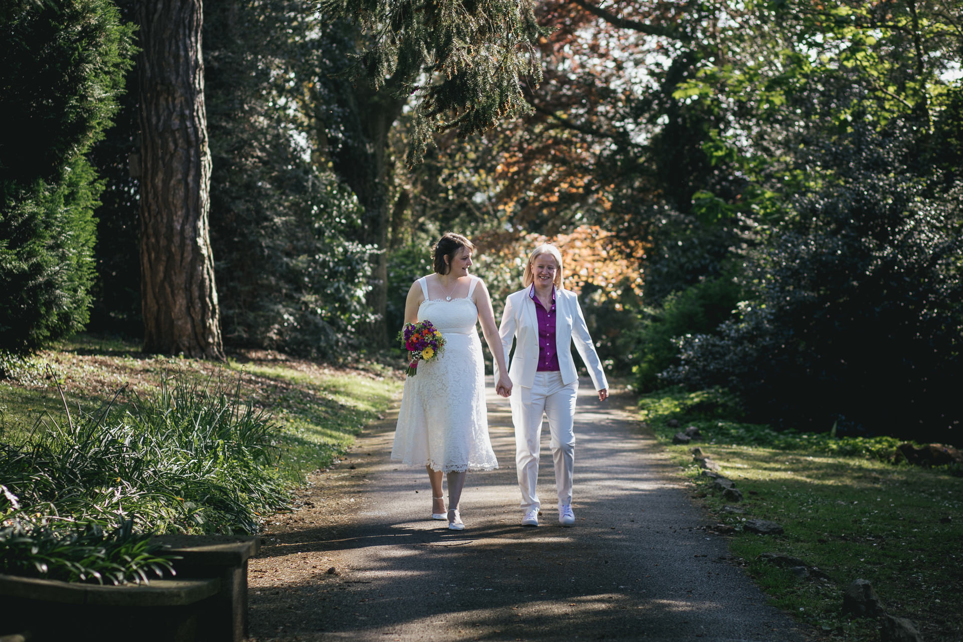 Two brides, just married, walking and smiling together