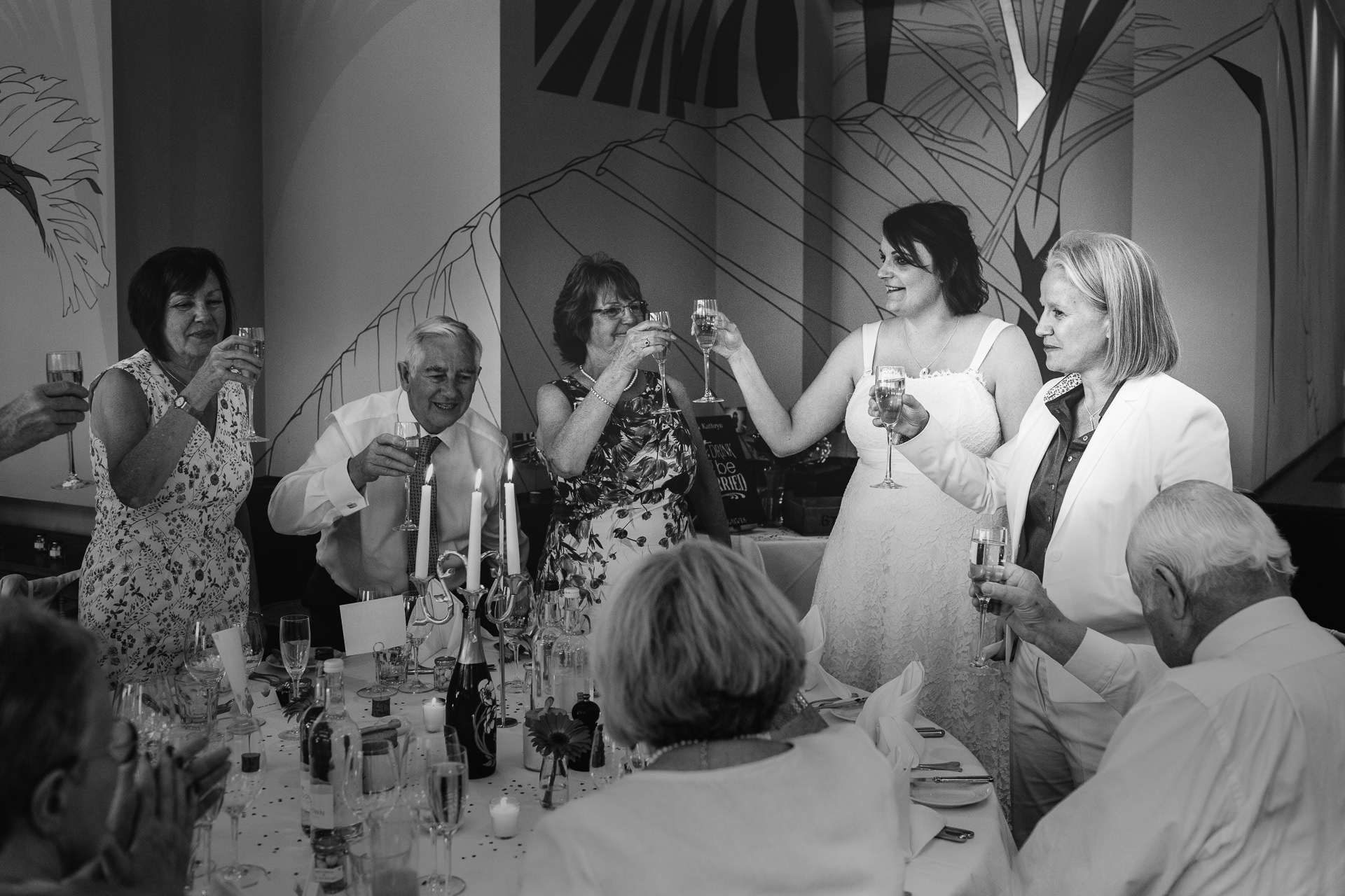 Two brides toasting their wedding
