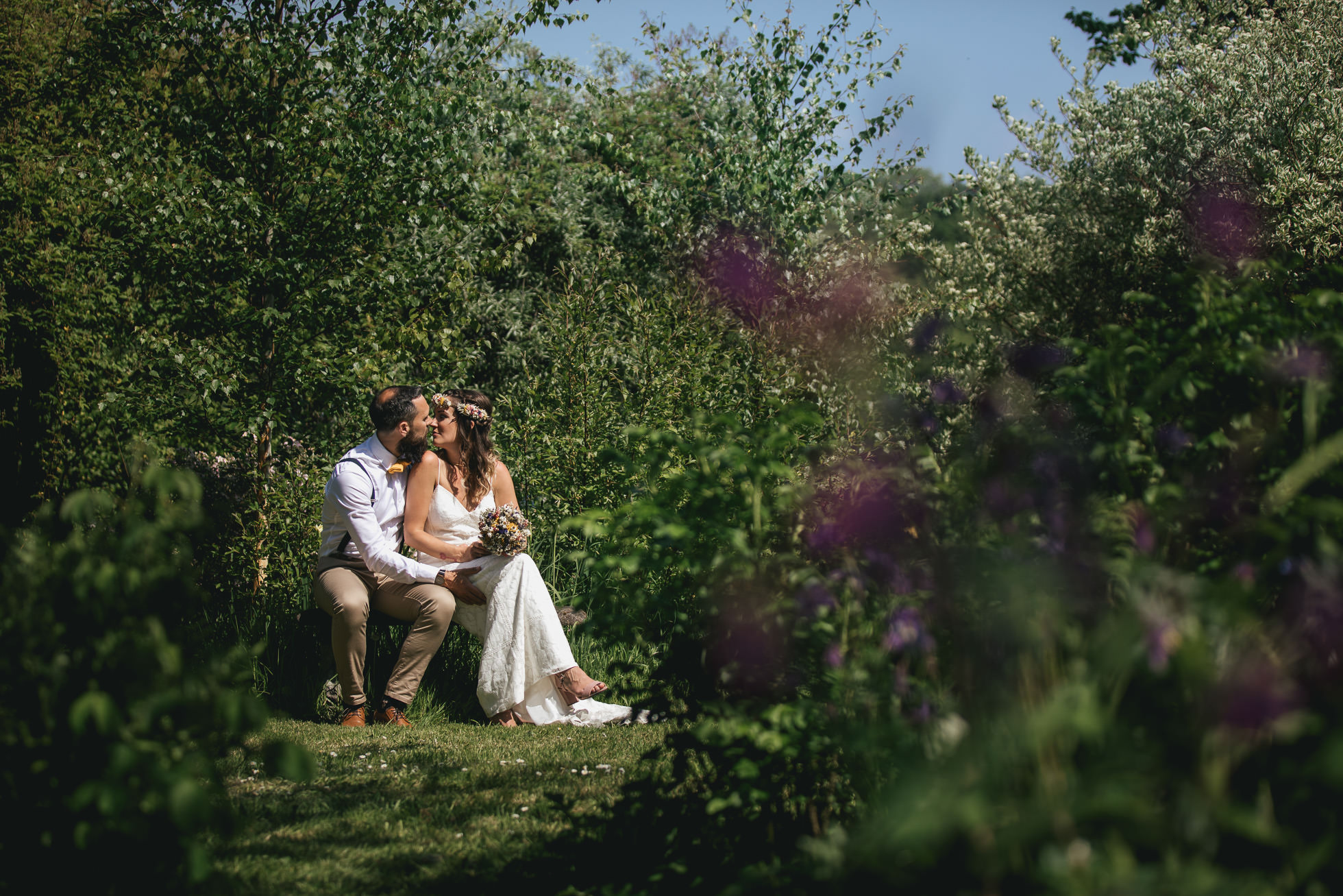 Bride and groom sitting in walled garden