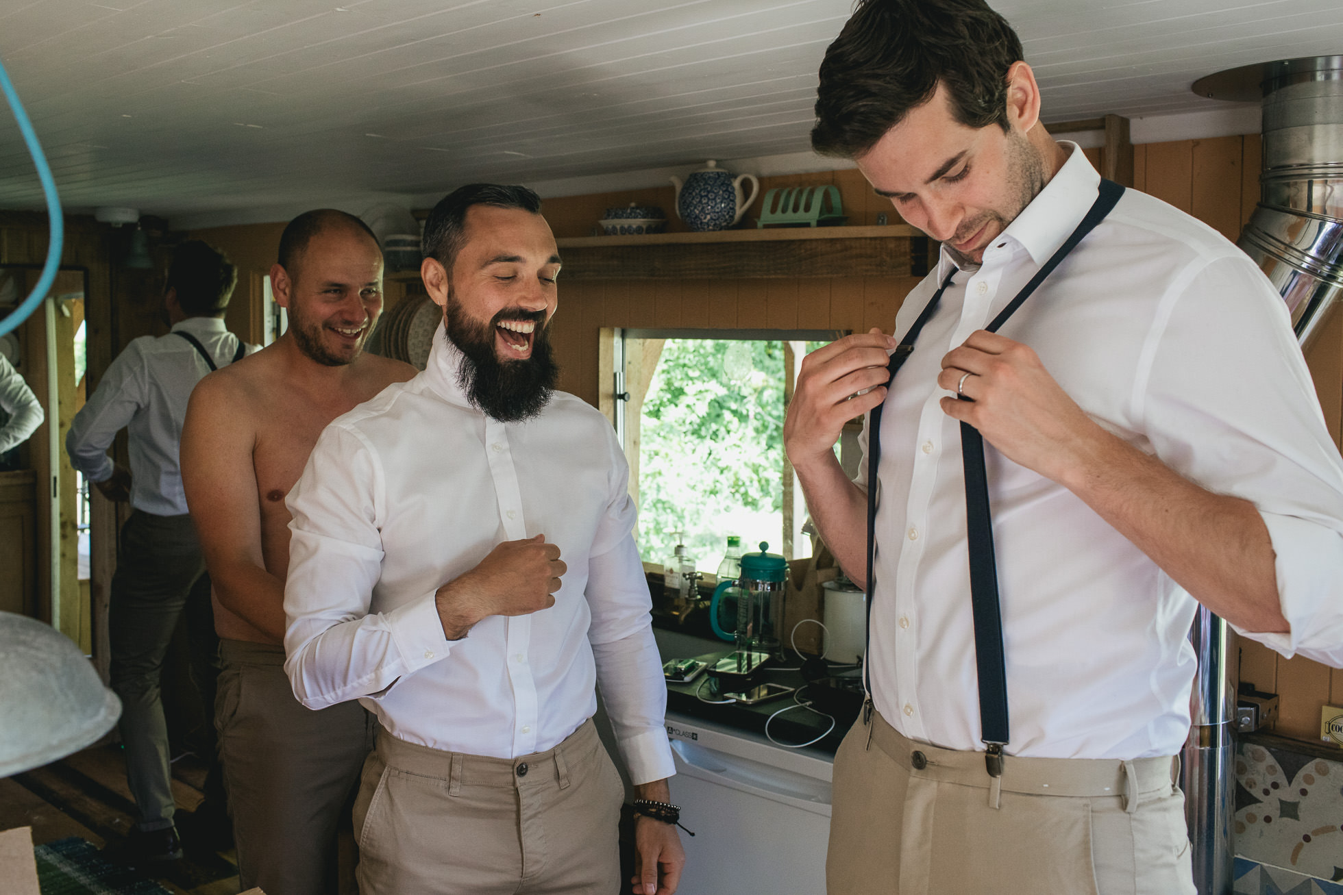 Groom and groomsmen laughing together