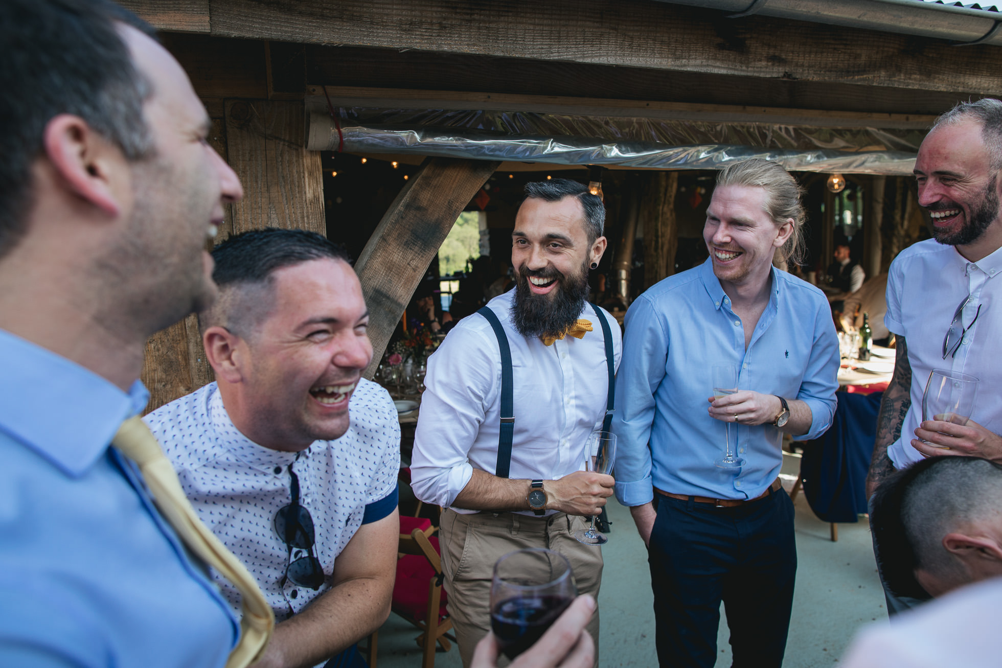 Groom laughing with friends