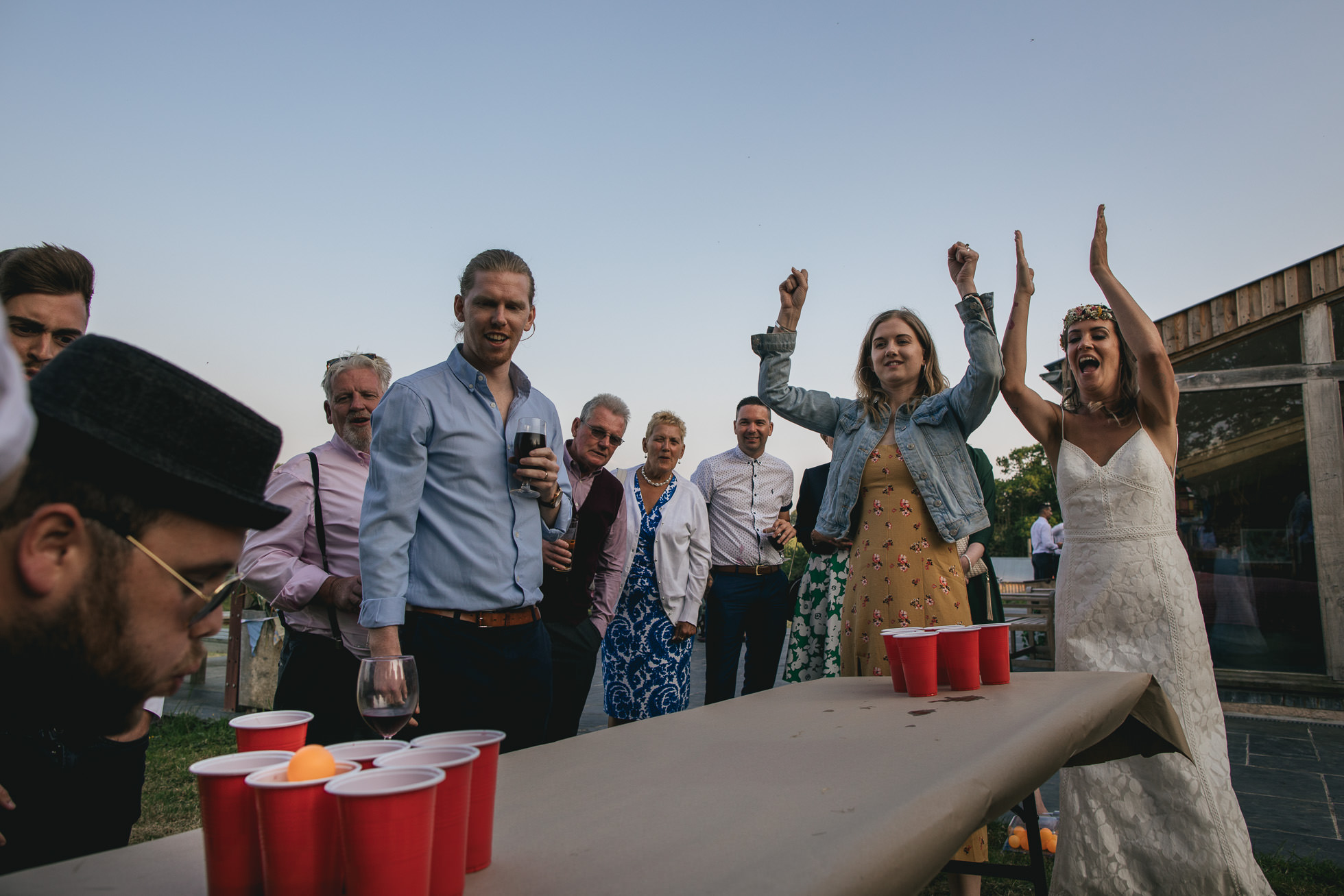 Wedding guests playing beer pong