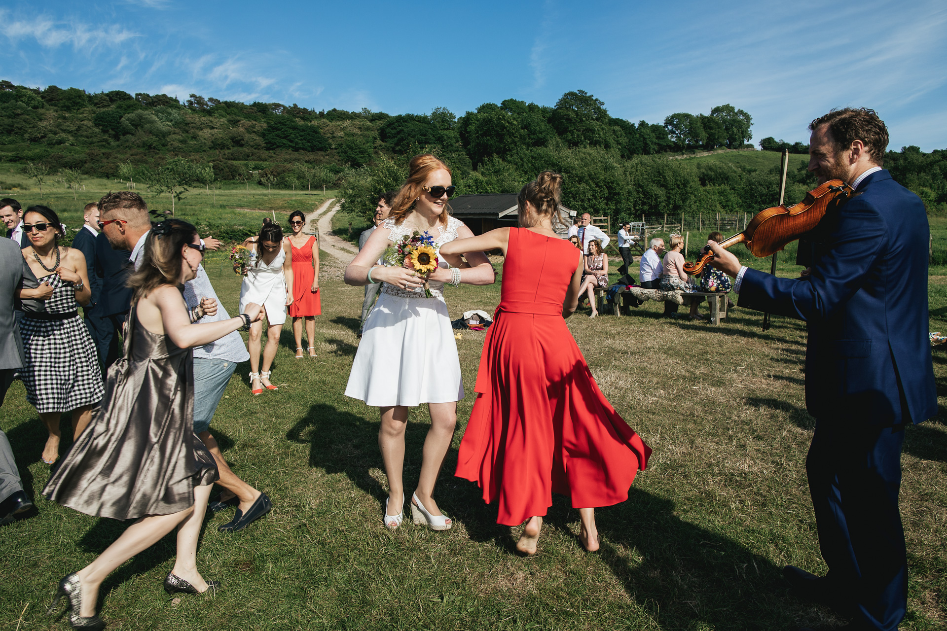 Wedding guests dancing in a field