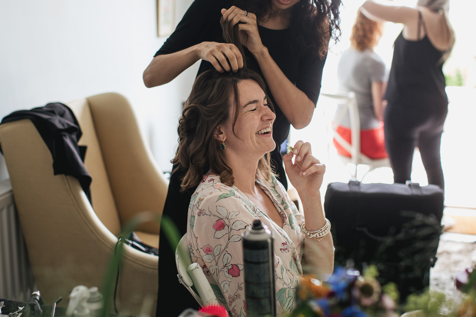Bride to be, laughing while having hair done