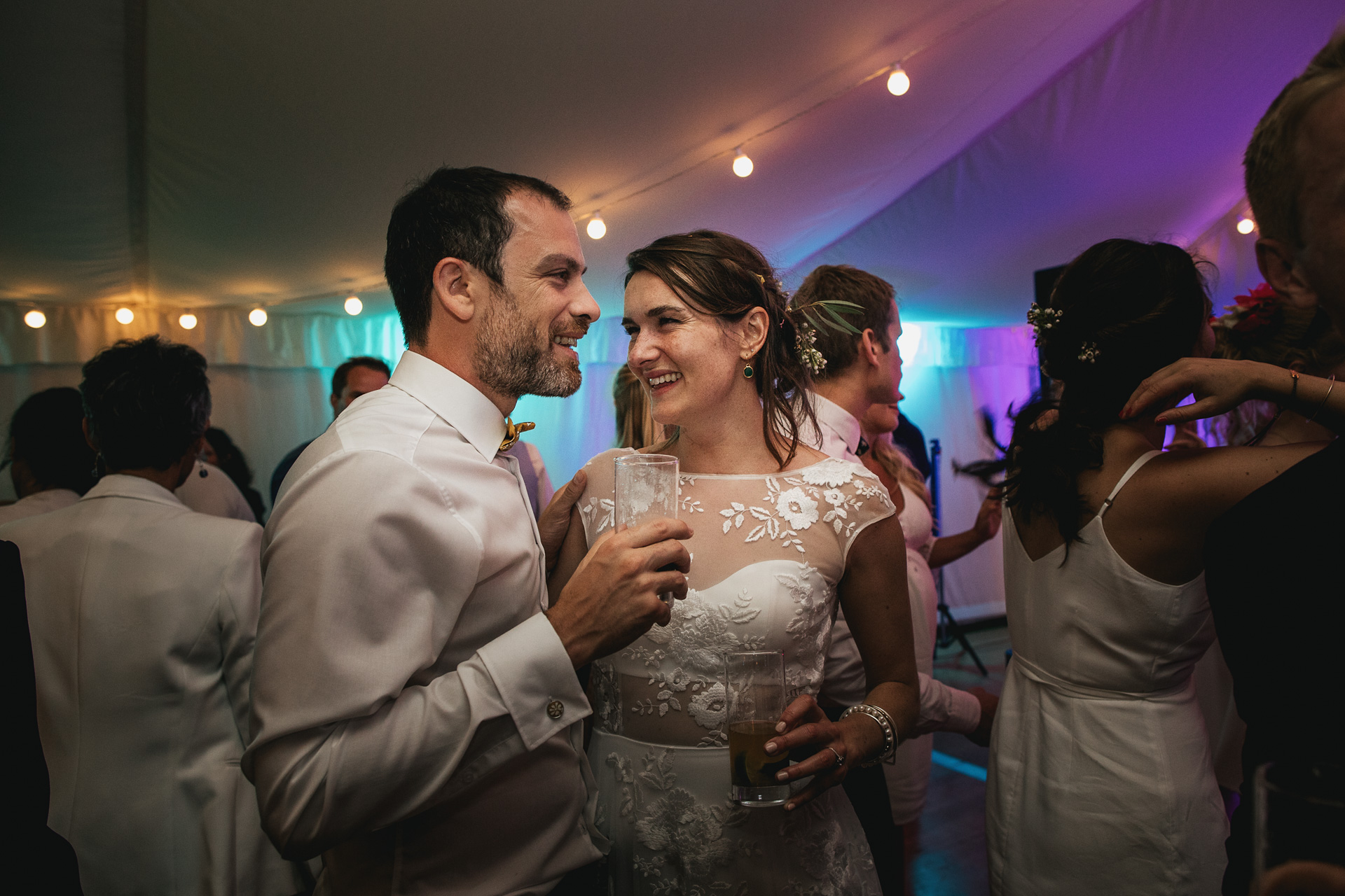 Bride and groom smiling on dance floor 