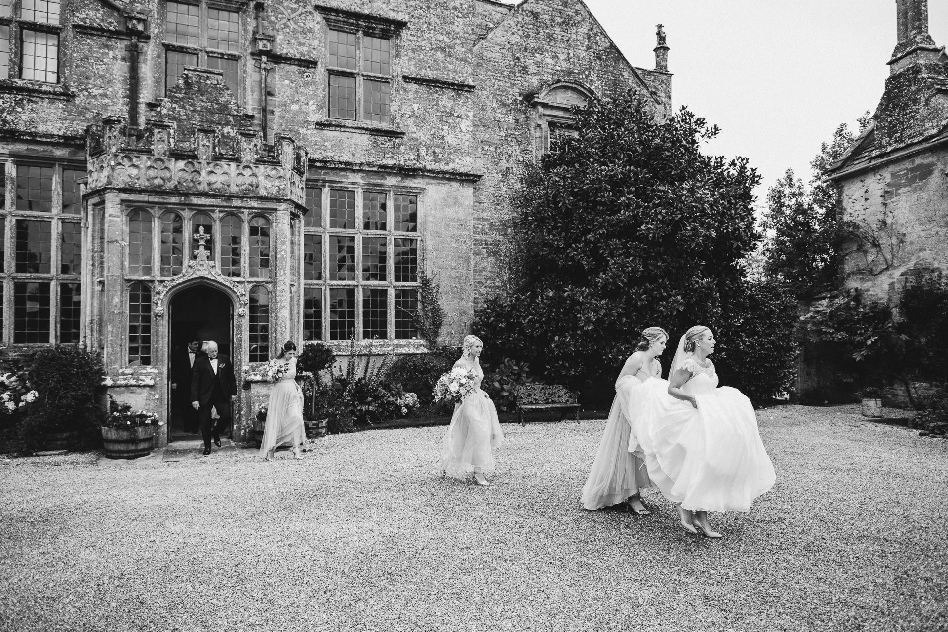 Bride and bridesmaids walking from Brympton House