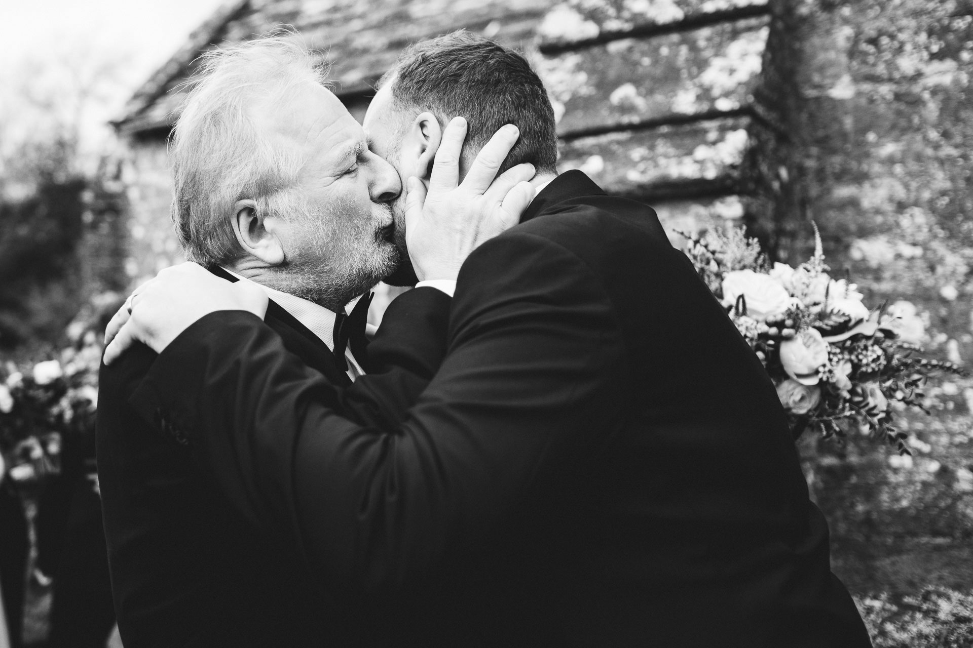 Father kissing groom