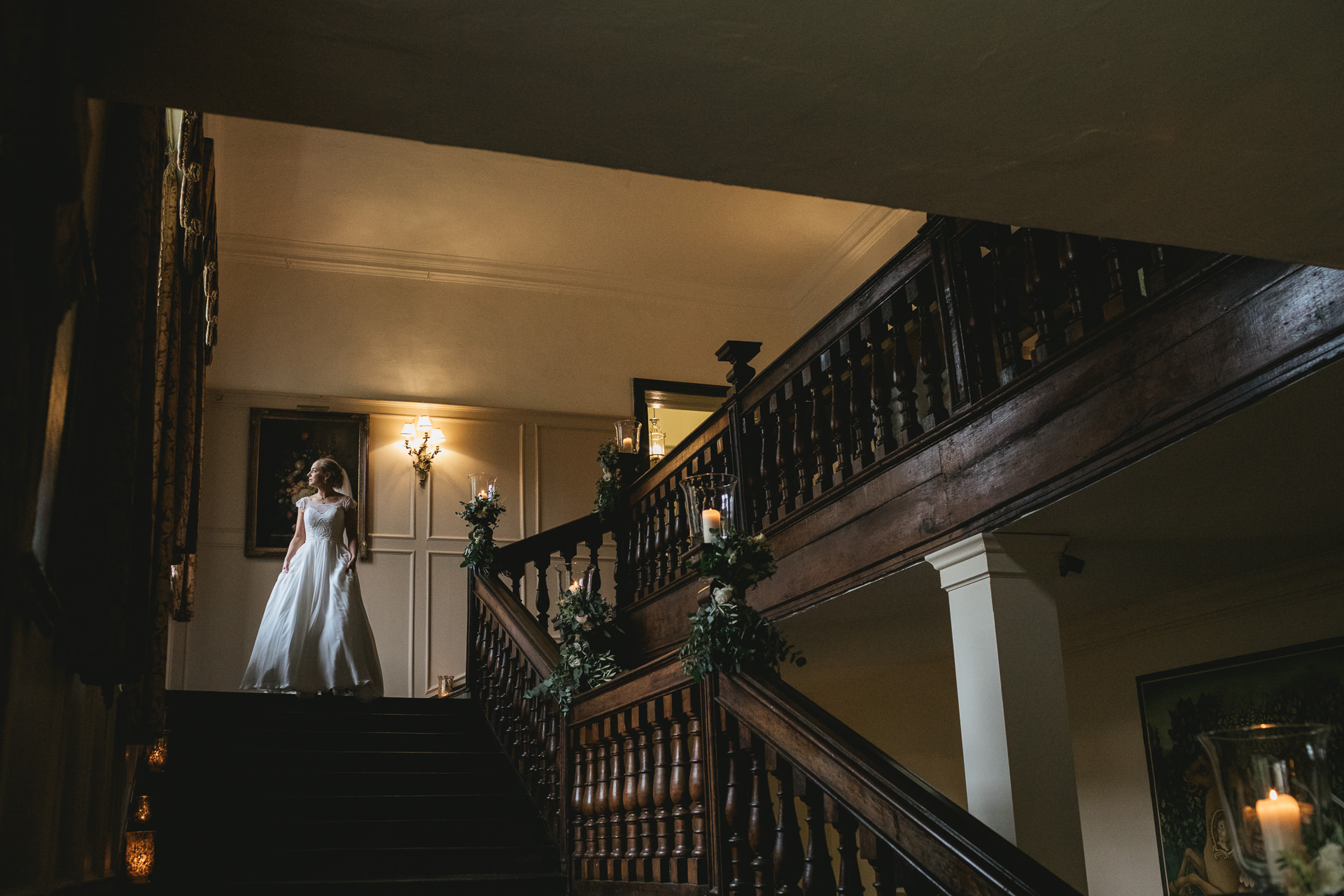 Bride in window light on stairway