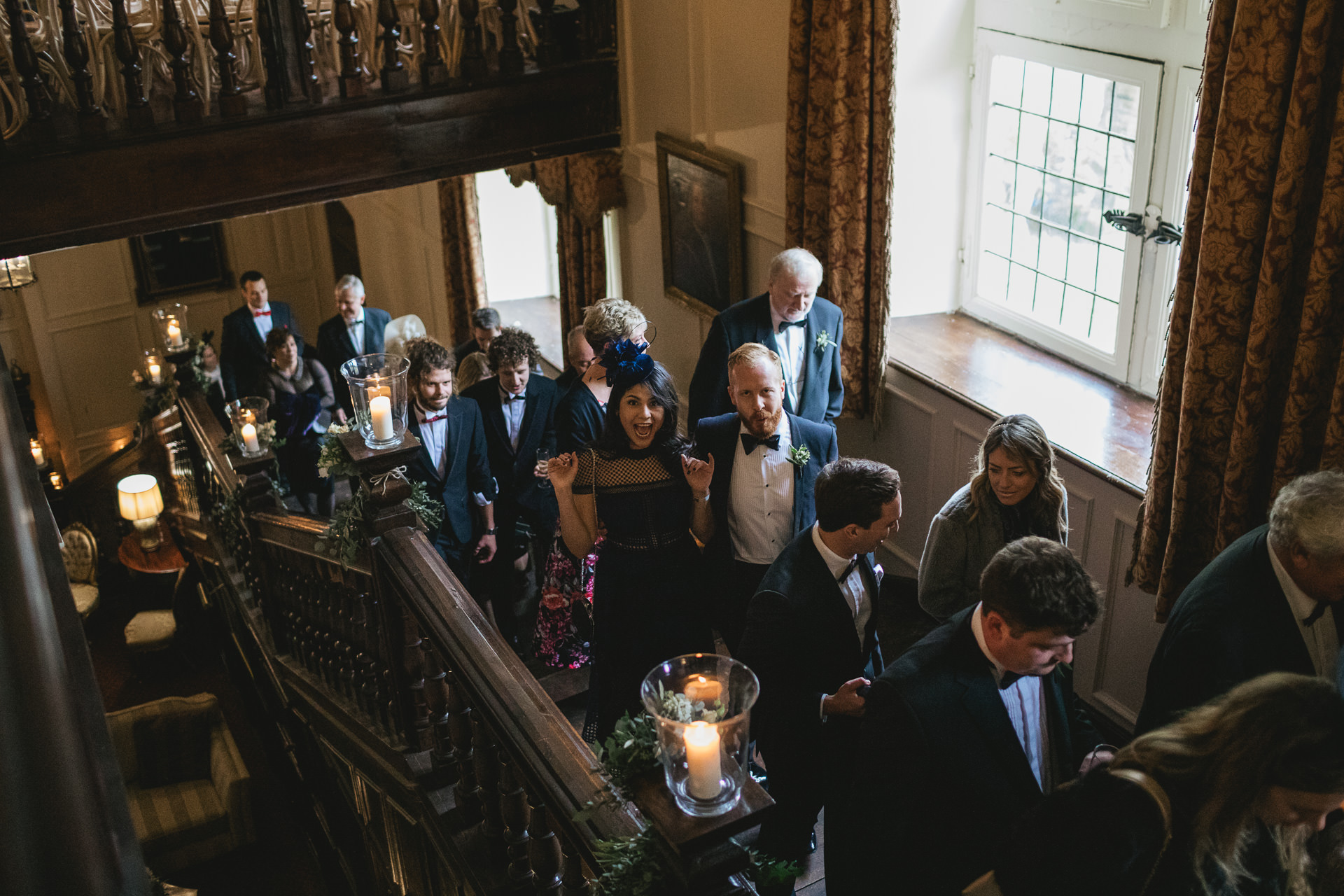 Wedding guests walking up a wide staircase