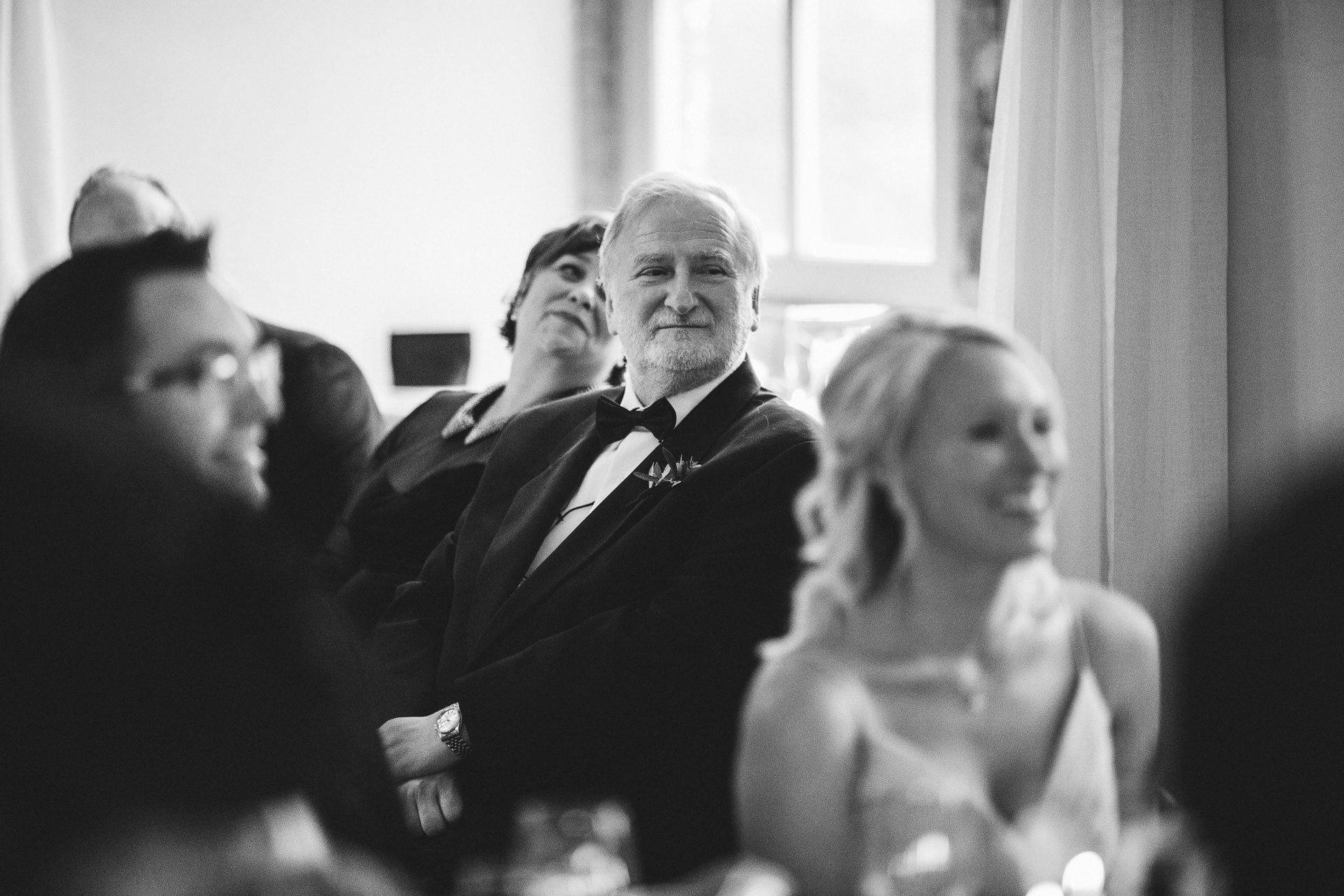 Father of groom listening to wedding speeches