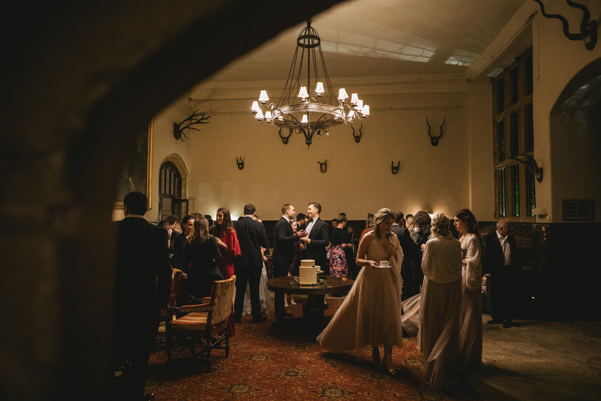 Wedding guests in the entrance hall of Brympton House