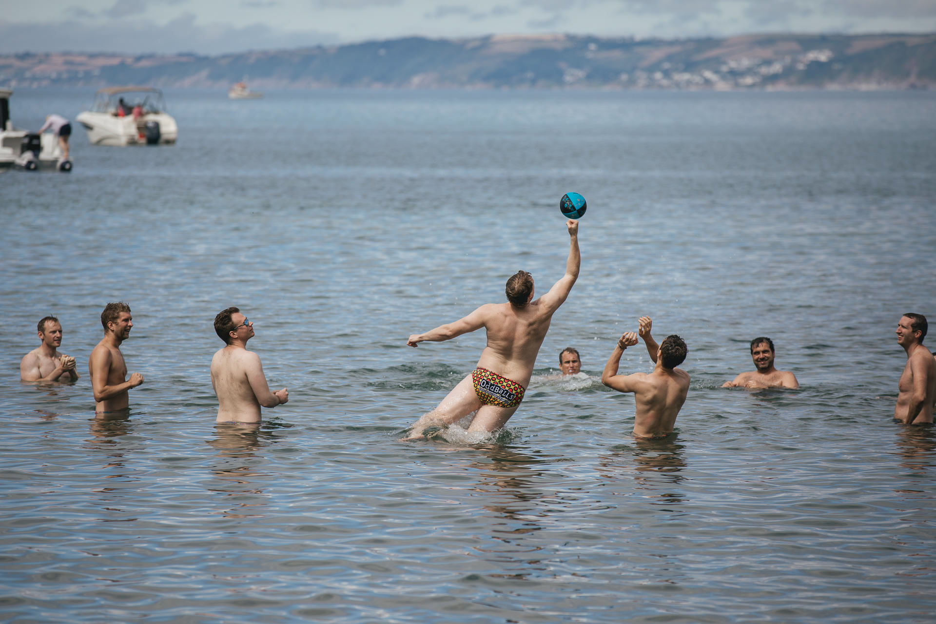 A group of men playing rugby in the sea