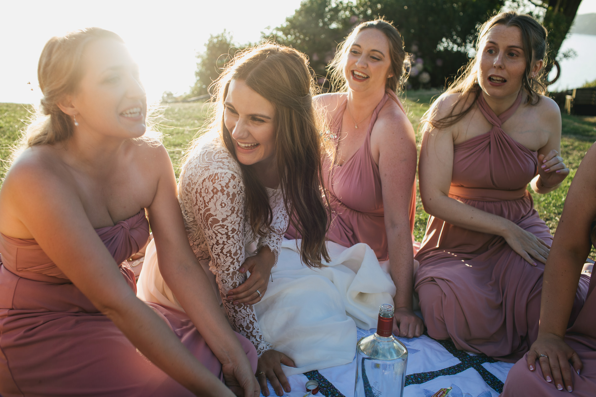 Bride and bridesmaids laughing 