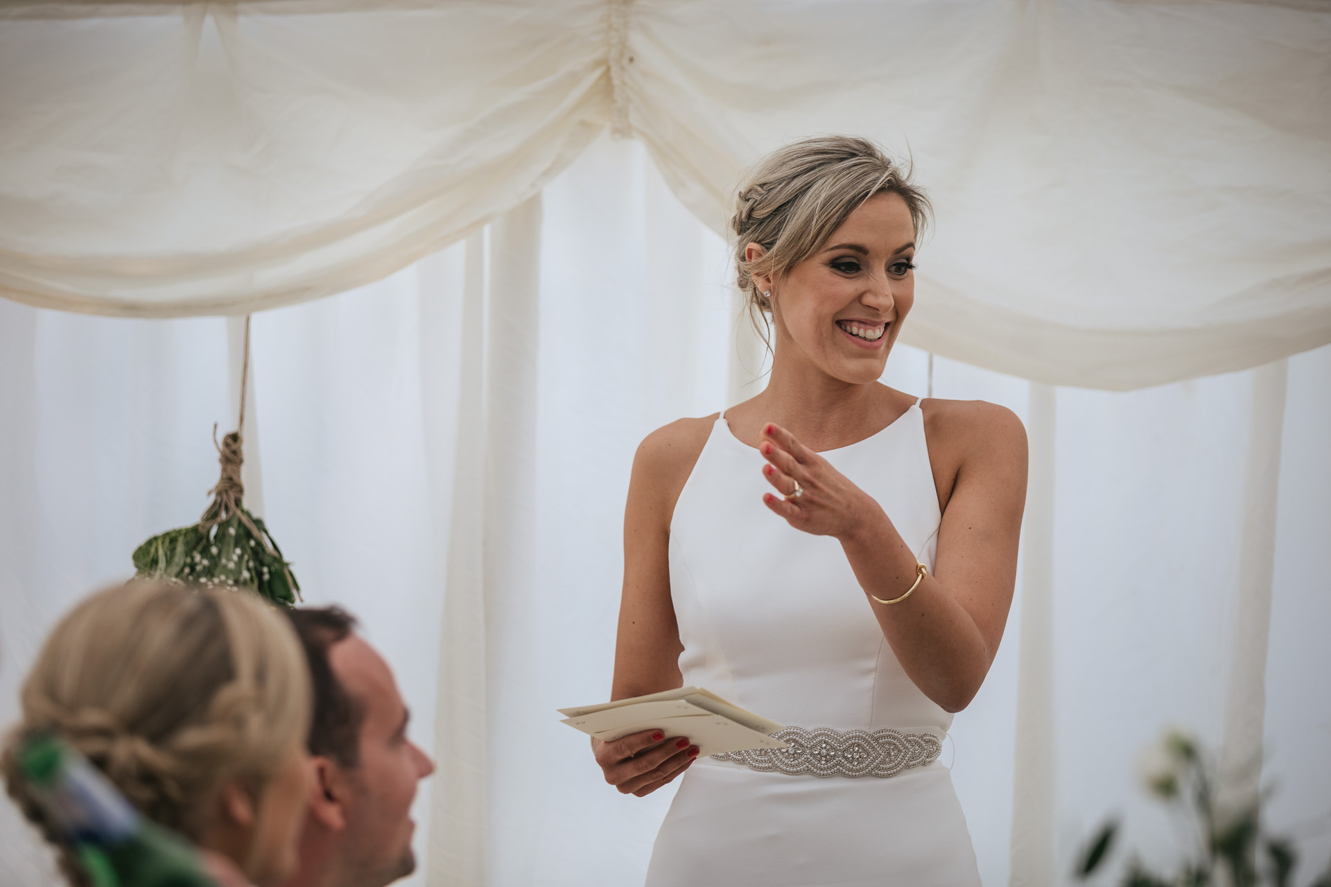 Bride giving wedding speech in a marquee