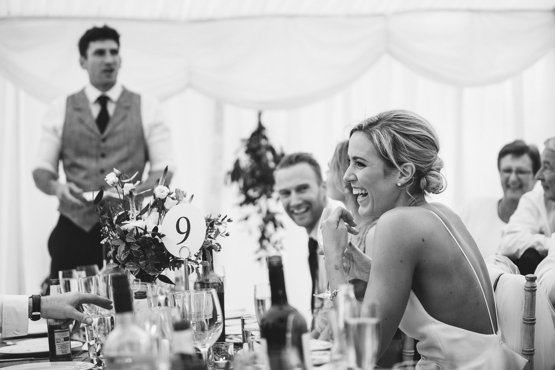 Bride laughing at groom's speech