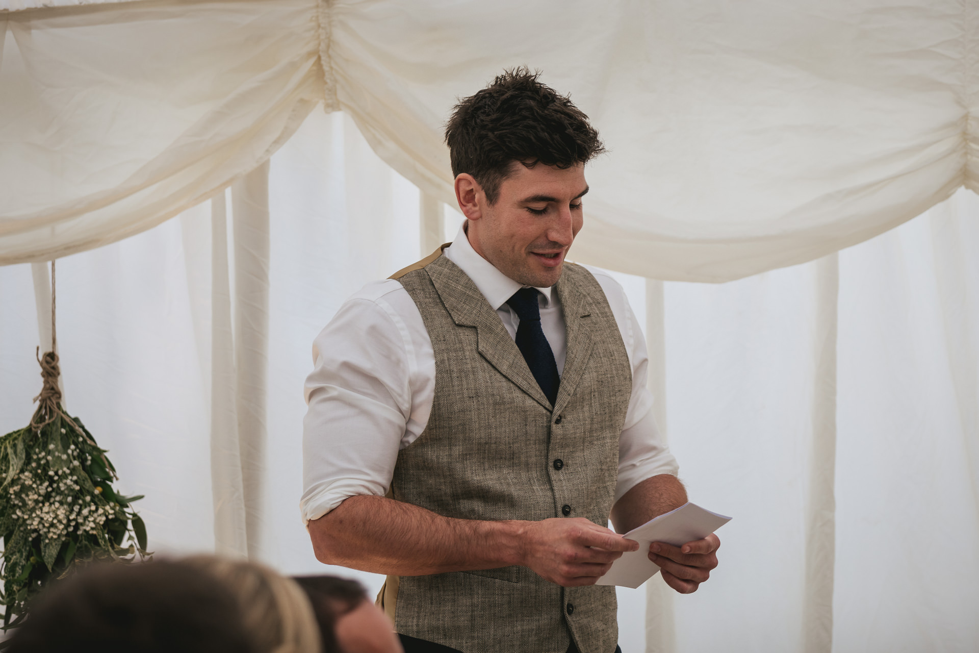 Groom giving speech in a marquee