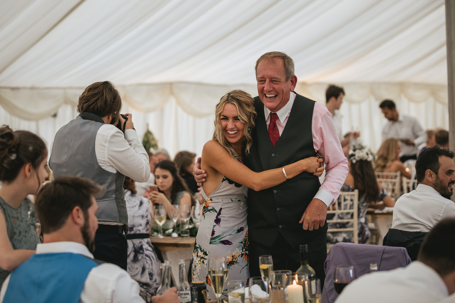 Wedding guests chatting in a marquee