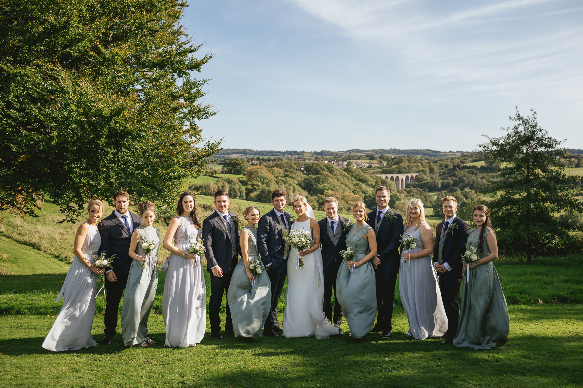 Bridal party group photo at The Grange Belluton, with Pensford Viaduct behind