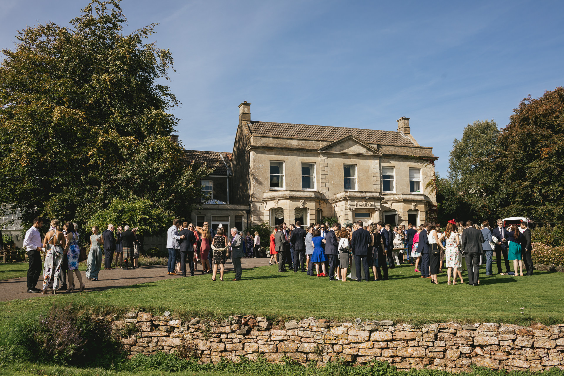 Wedding guests standing on the lawn at The Grange Belluton