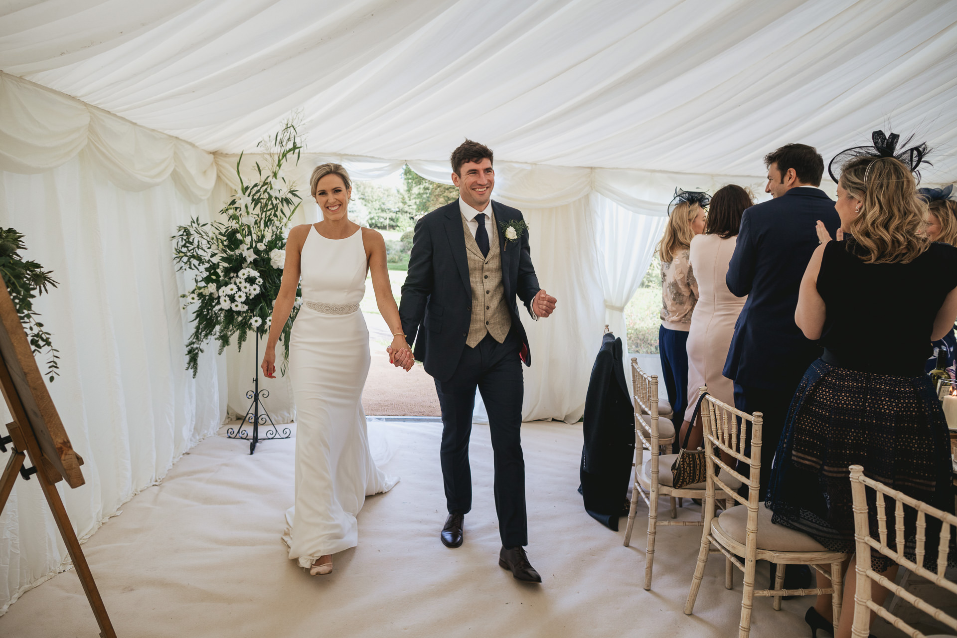 Bride and groom entering their wedding marquee