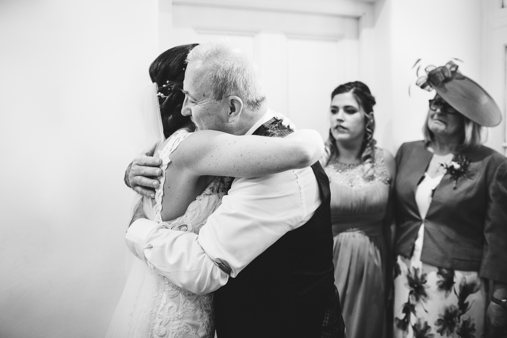 Bride's father hugging her