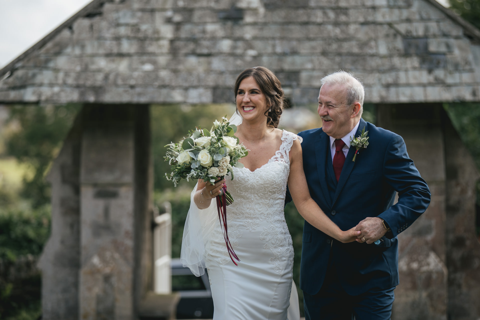 Bride and her father walking up church pathway