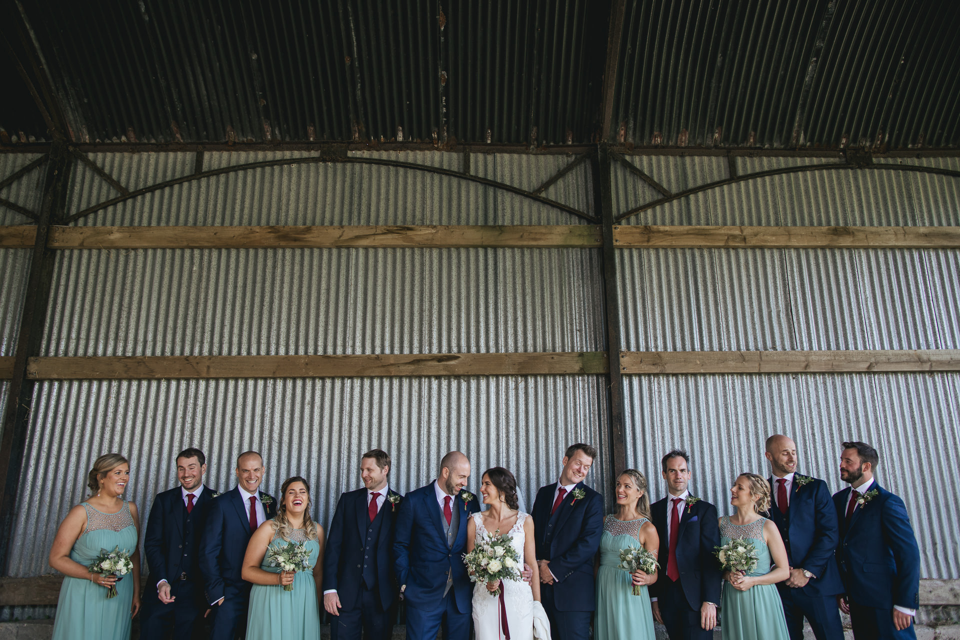 Bridal party group photo in a barn