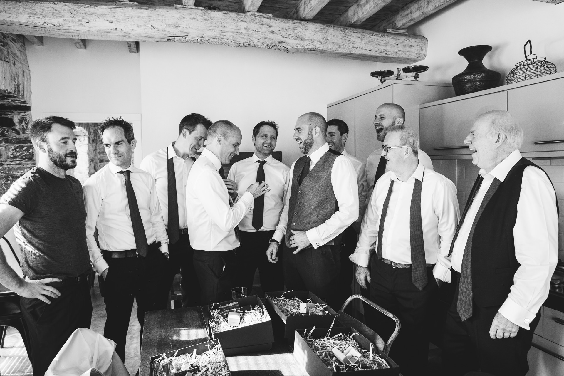 Groom and groomsmen laughing together