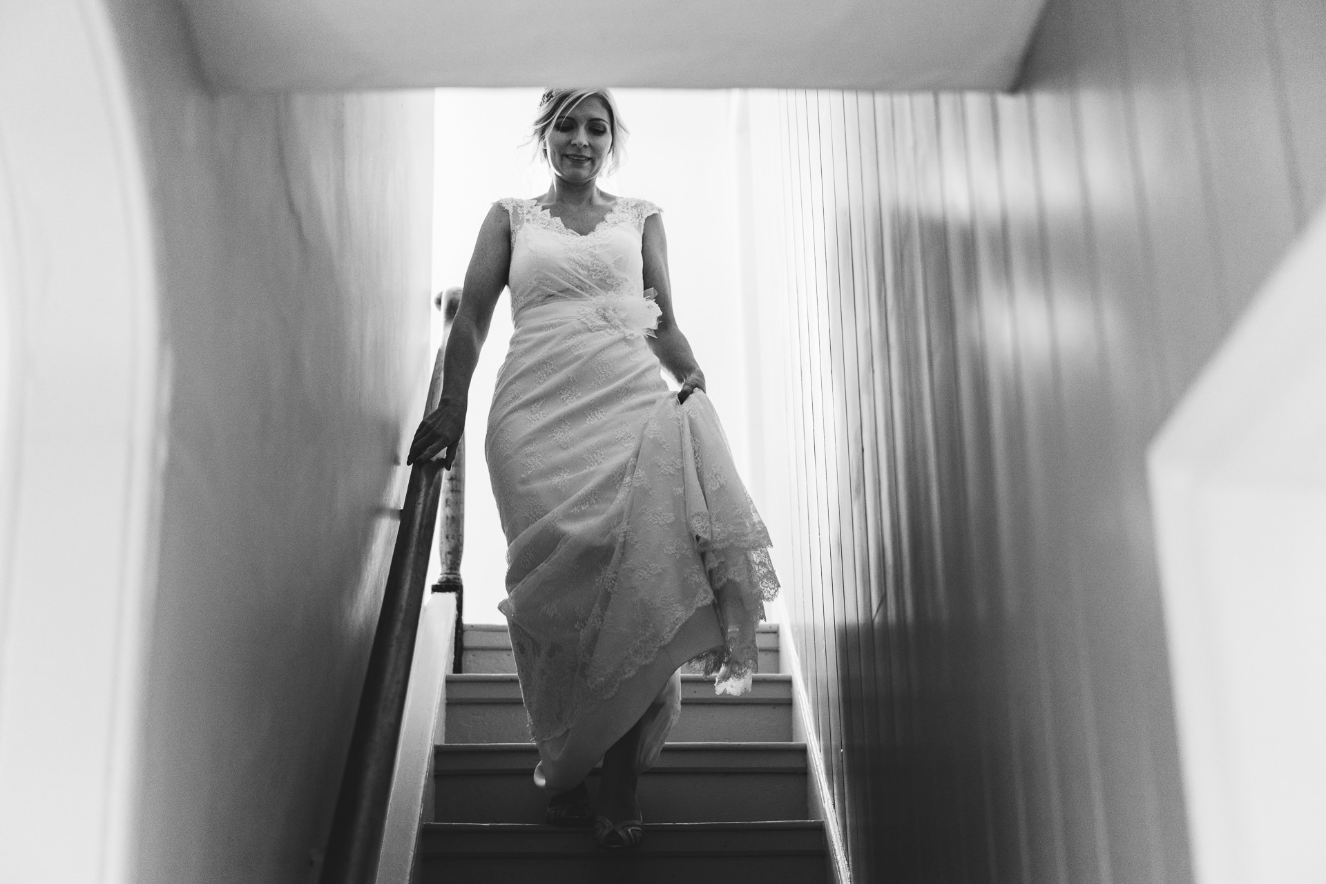 Bride walking down stairs in wedding dress