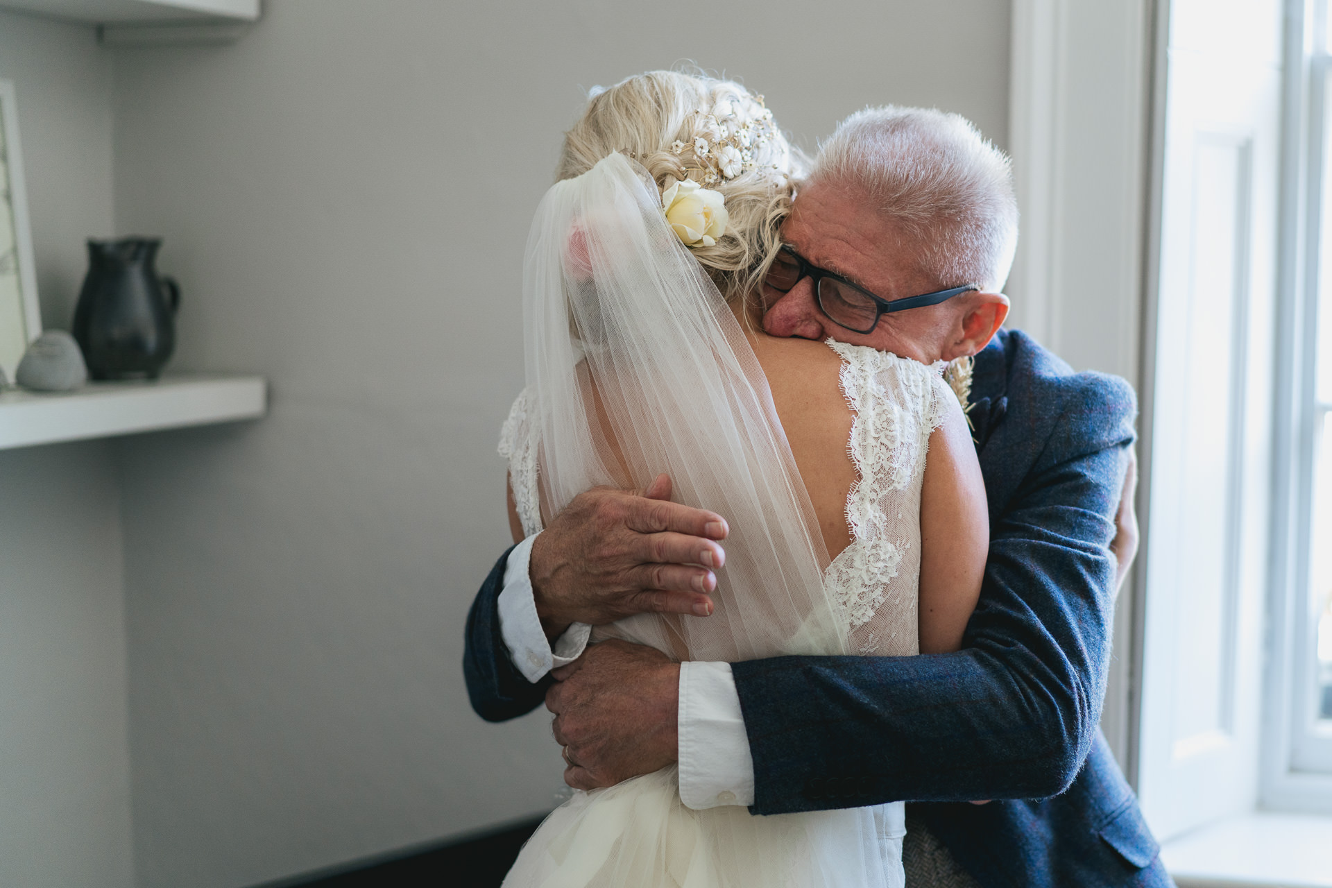 Father hugging daughter in wedding dress