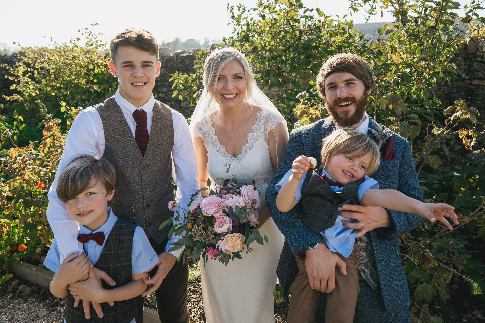 Bride and groom with family in the kitchen garden