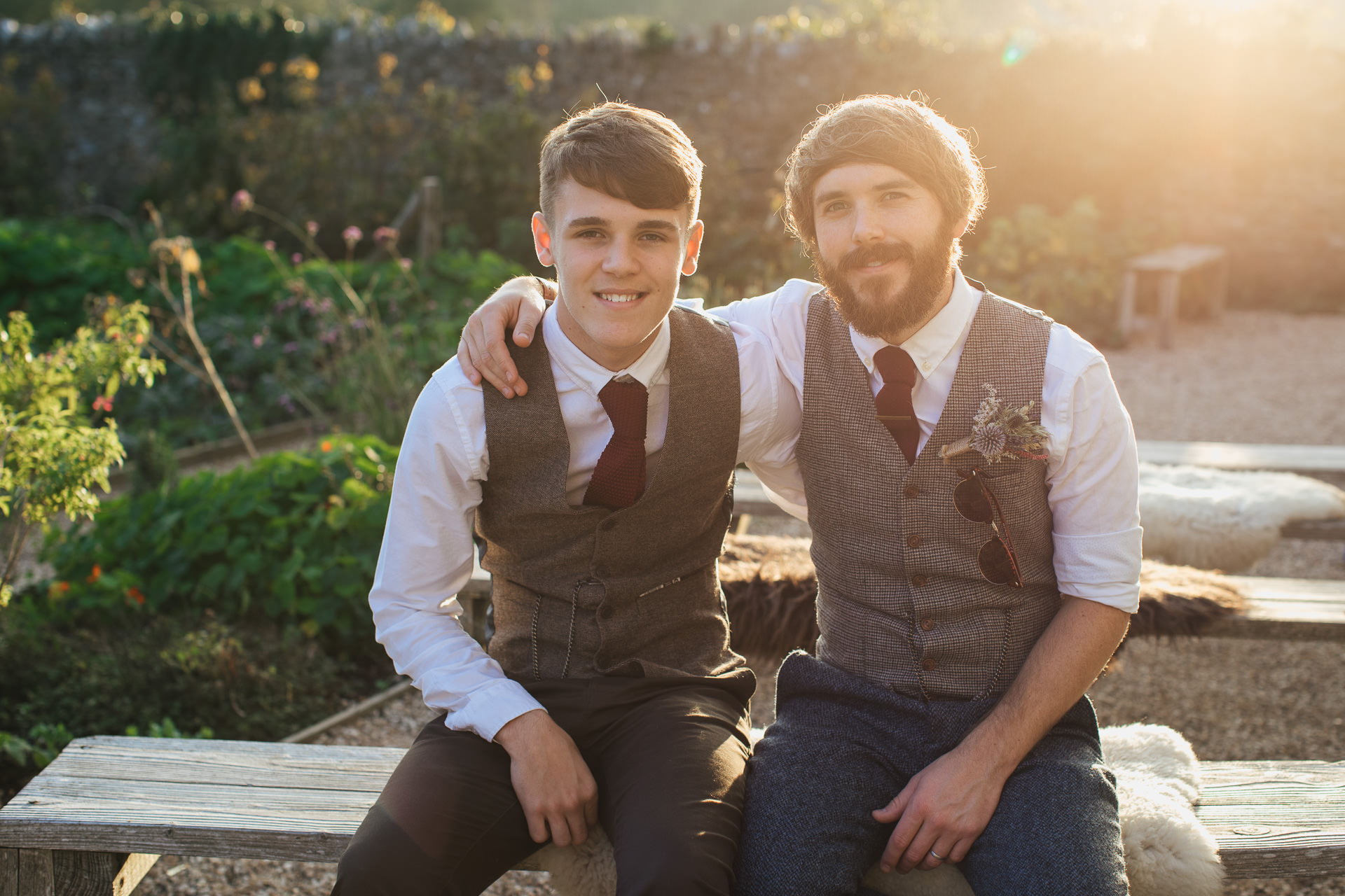 Groom with older son in evening sunlight
