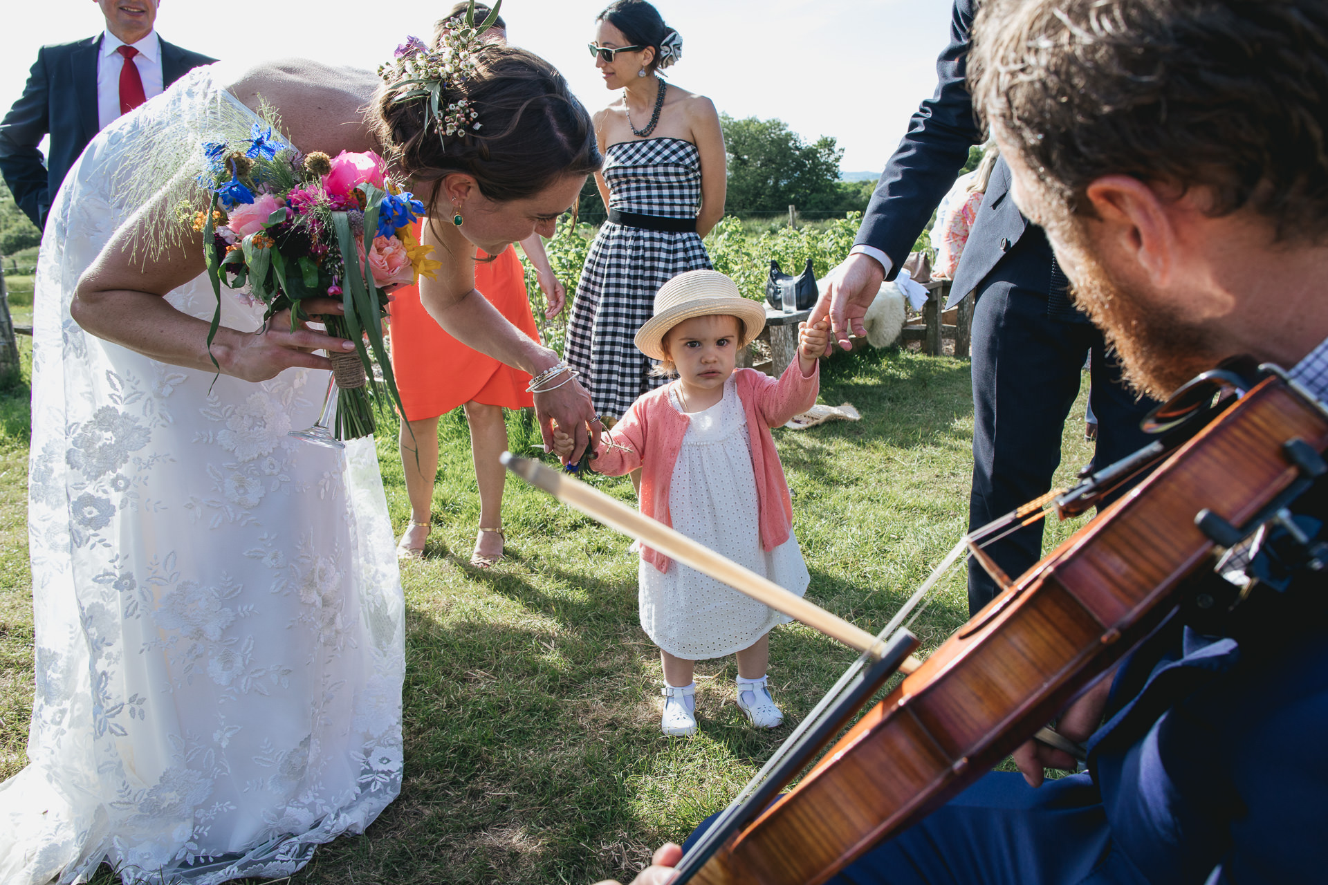 Flower girl frowning at musicians