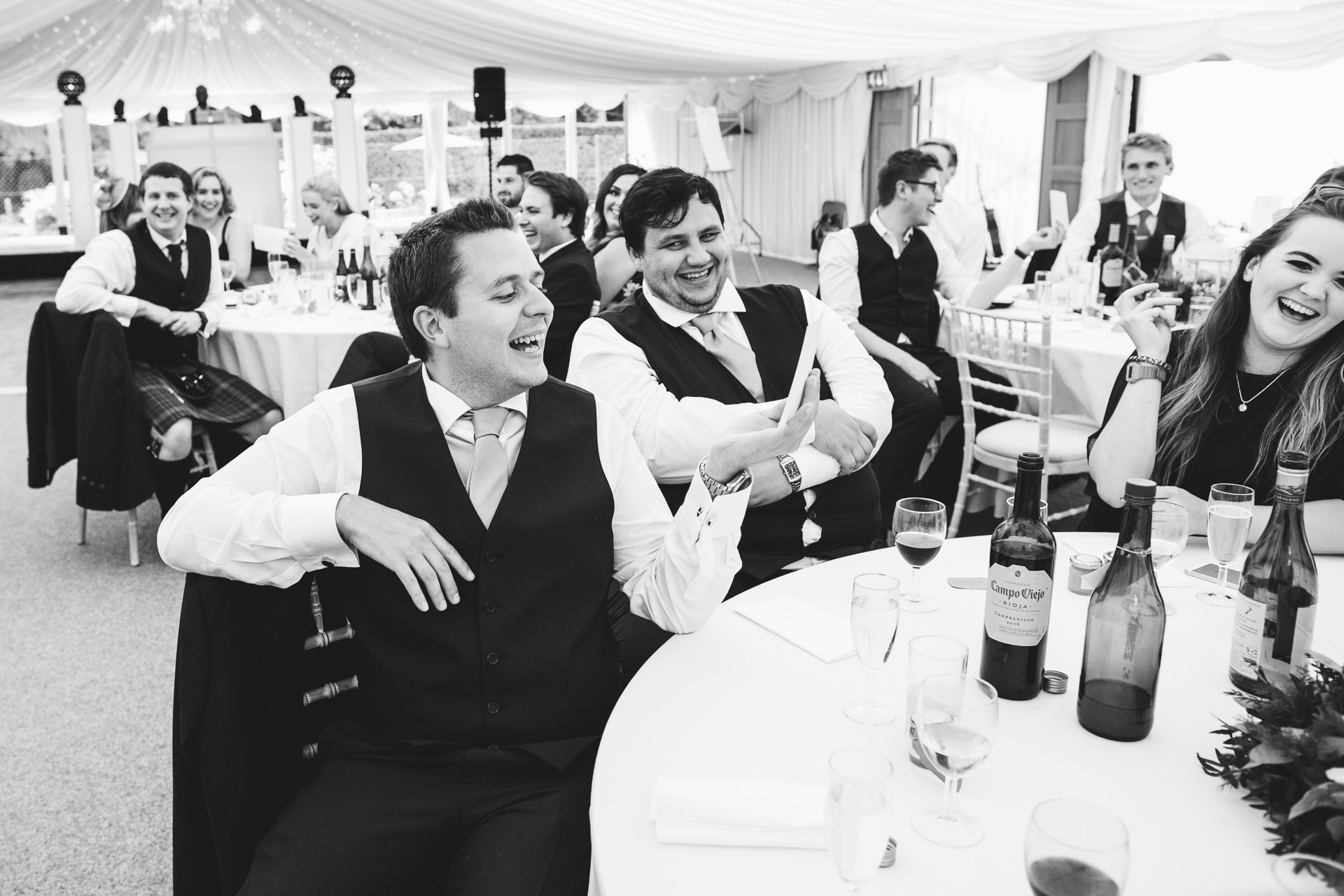 Guests laughing during wedding speeches