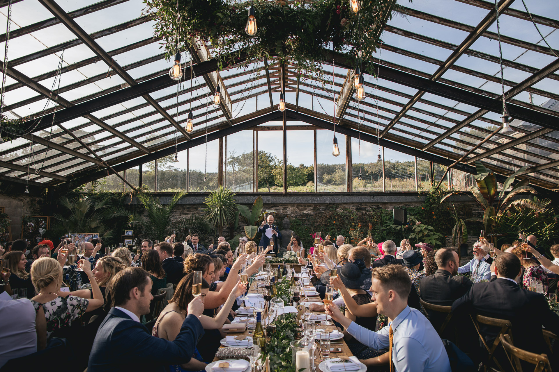 Anran glasshouse with guests toasting wedding speeches