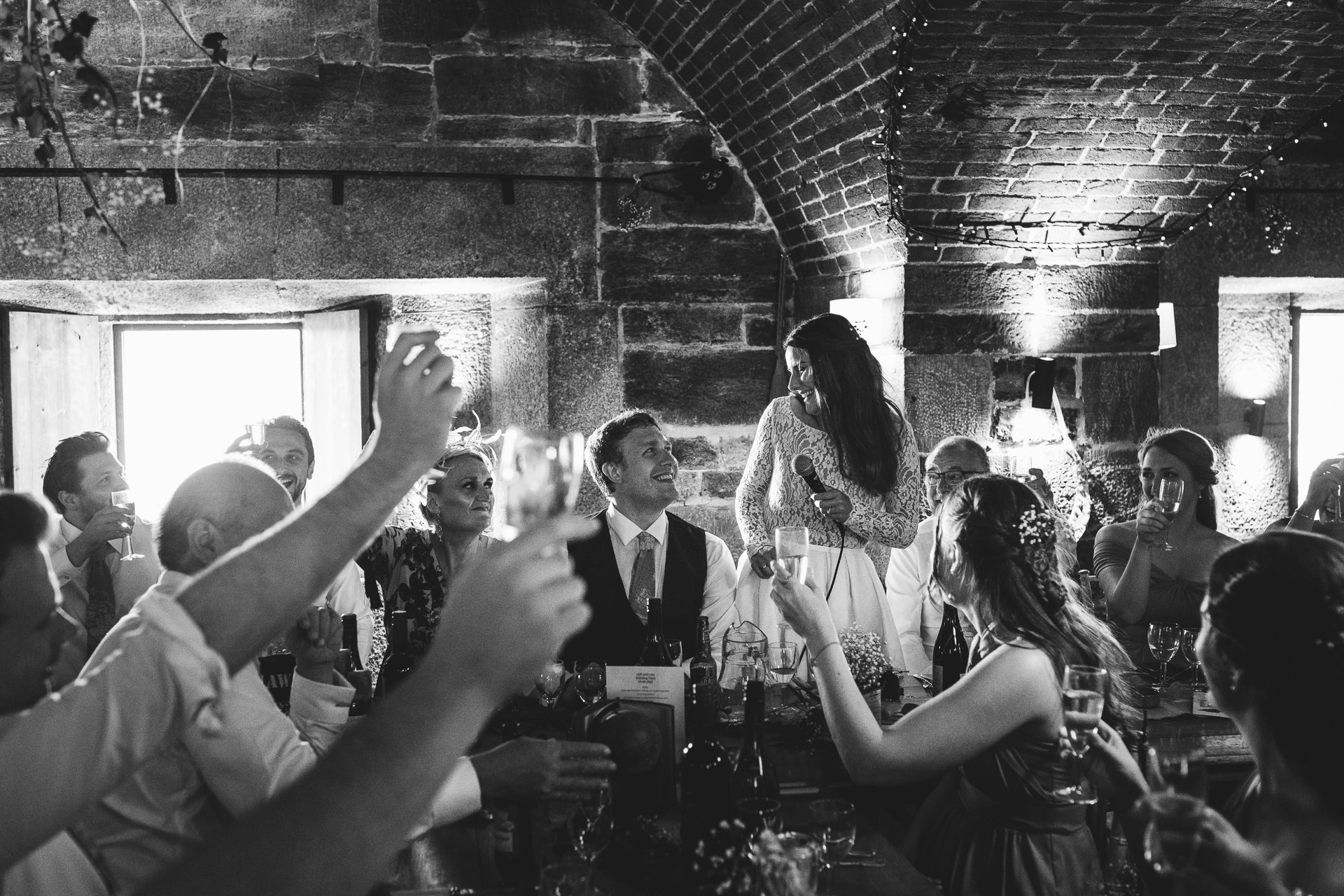 Wedding guests toasting bride's speech