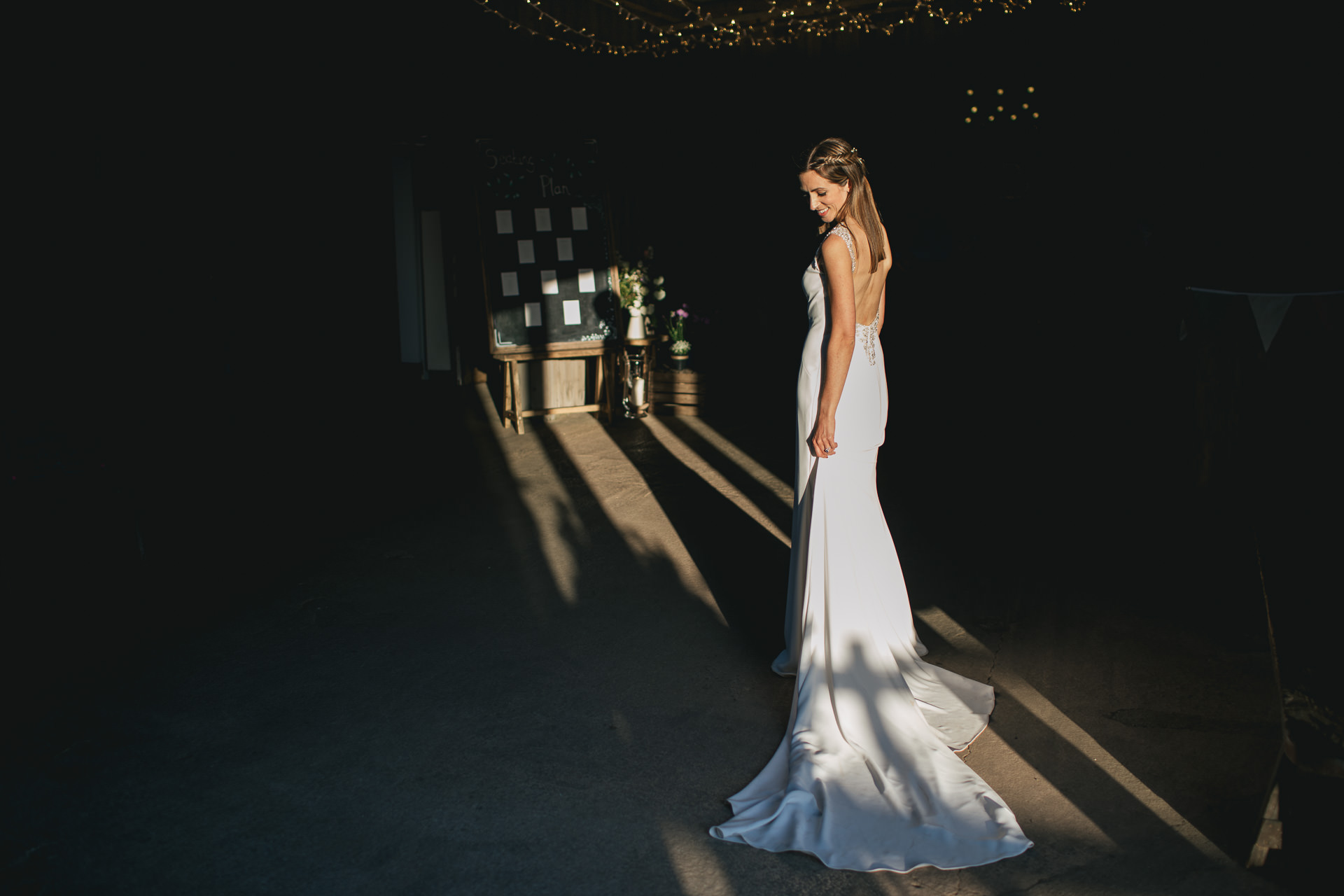 Bride standing in a shaft of light