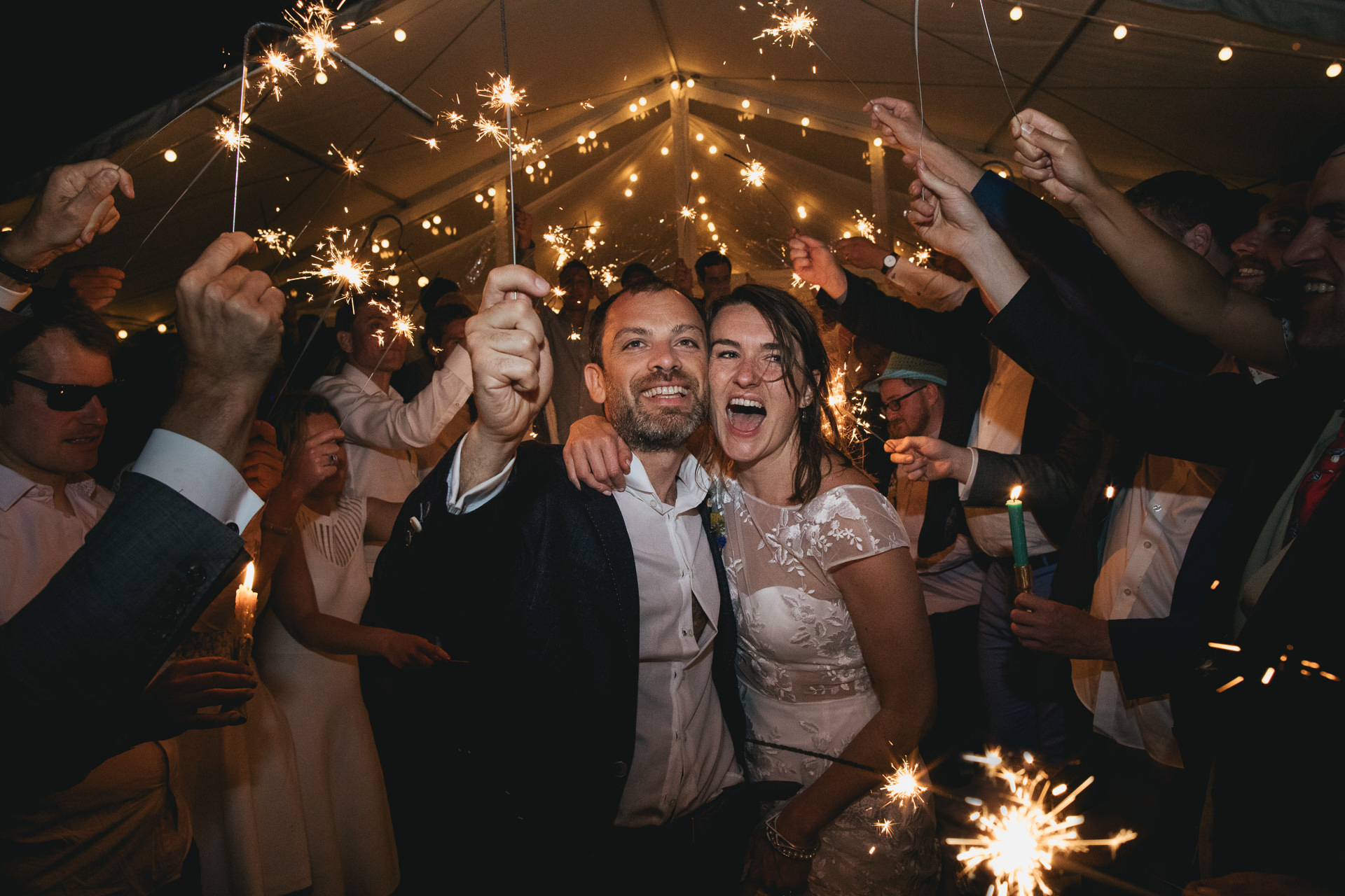 Bride and groom during sparkler exit from wedding party
