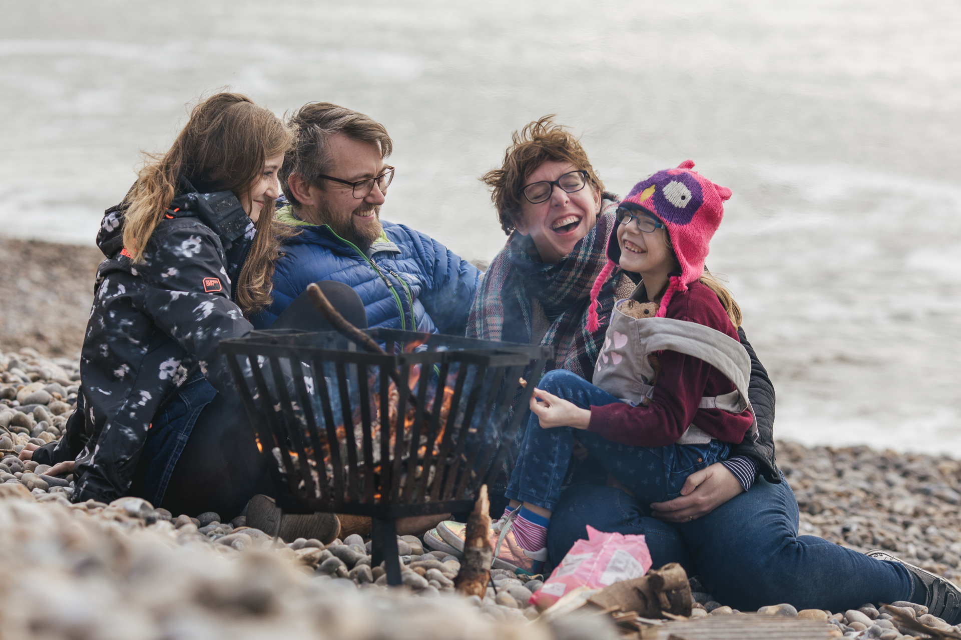 A family laughing together on a beach
